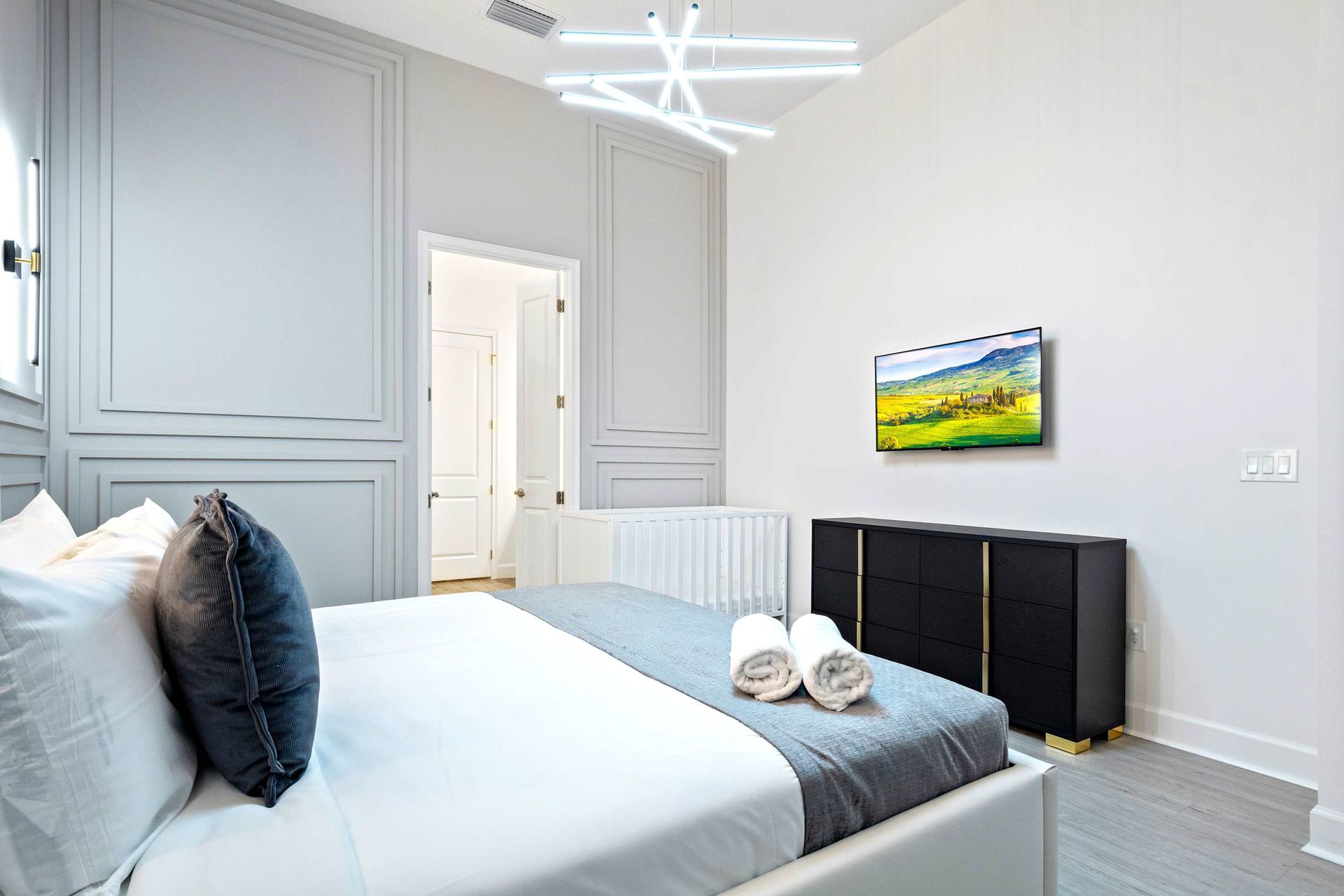 Elegant bedroom with modern accents, plush bedding, and ensuite bathroom access
