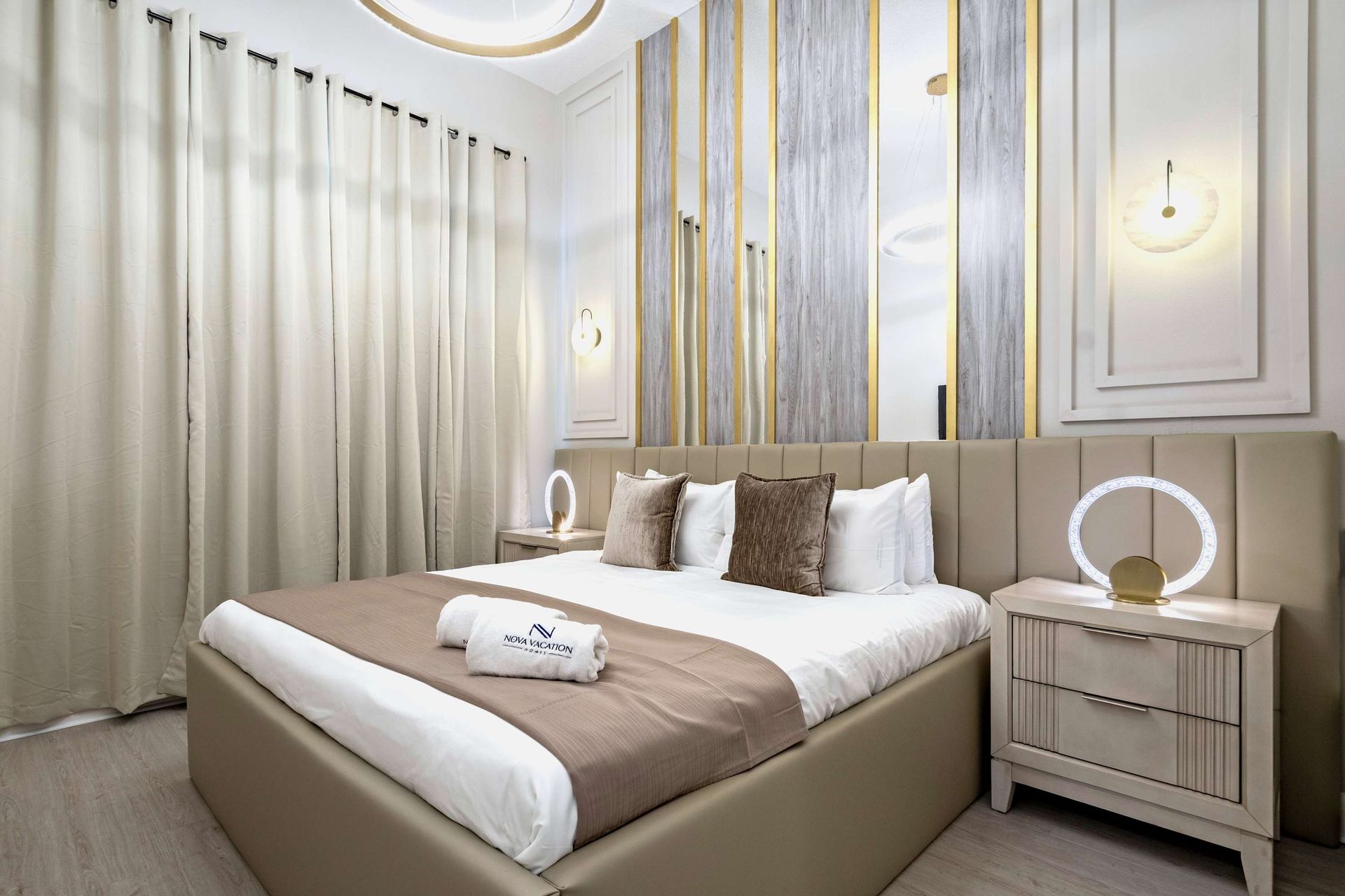 Serene and stylish bedroom with soft tones, modern lighting, and a cozy king bed
