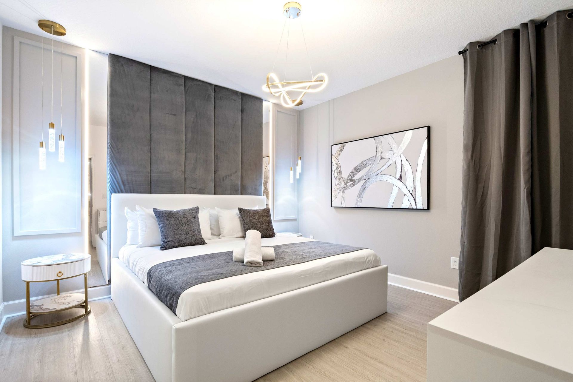 Contemporary bedroom with sleek design, cozy king bed, and artistic modern touches
