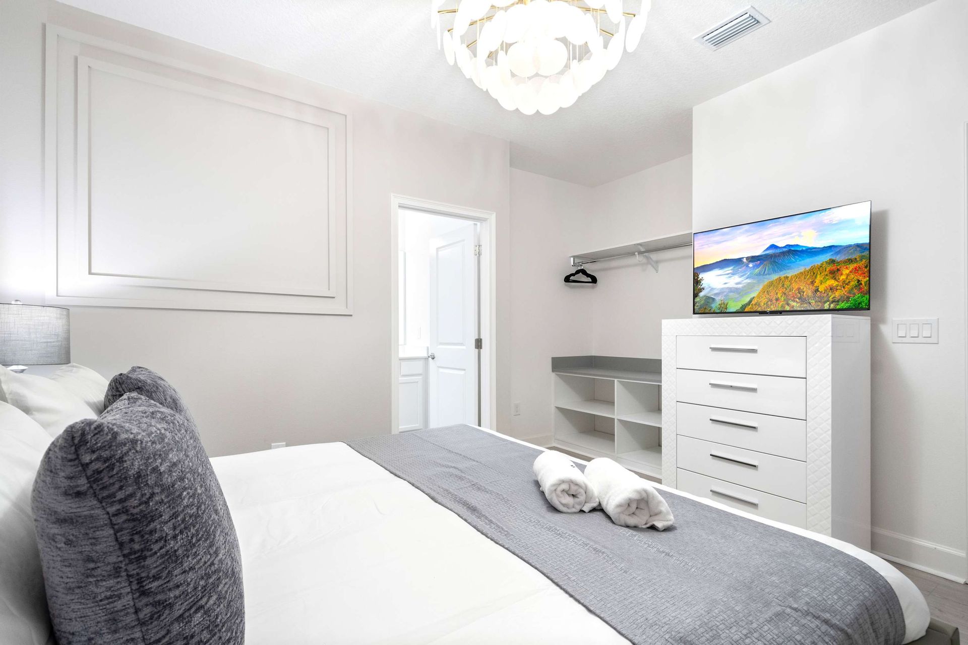 Contemporary bedroom with sleek design, cozy king bed, and artistic modern touches
