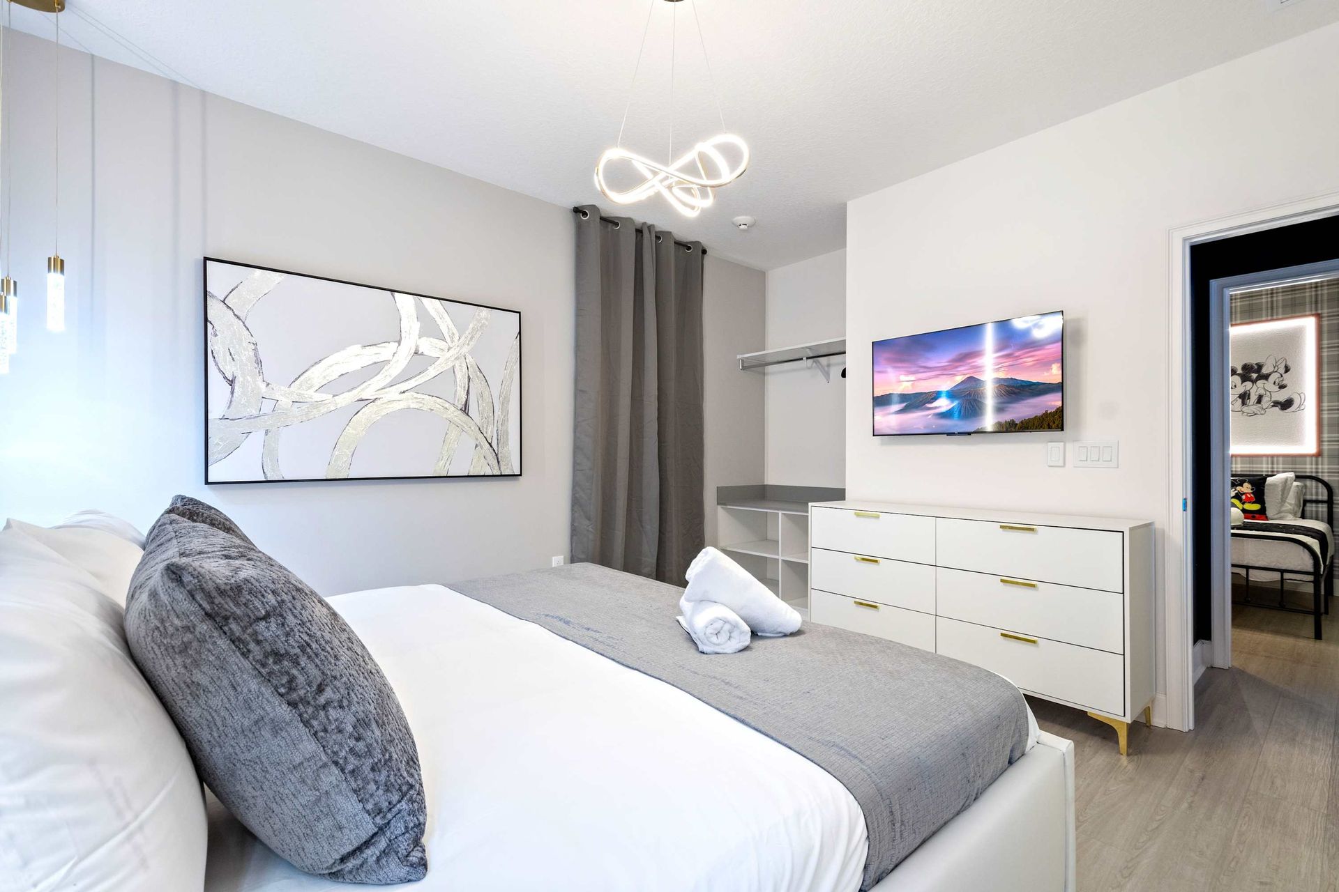 Contemporary bedroom with sleek design, cozy king bed, and artistic modern touches
