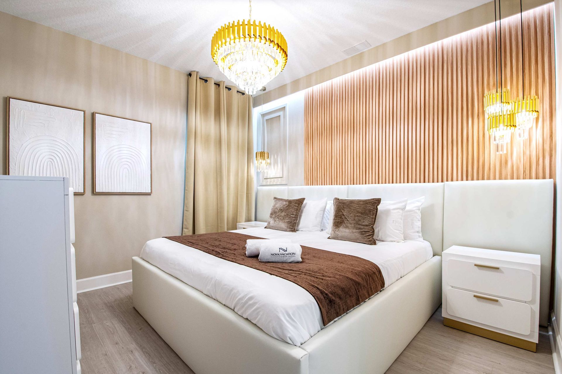 Warm and luxurious bedroom with gold accents, elegant lighting, and a plush king bed
