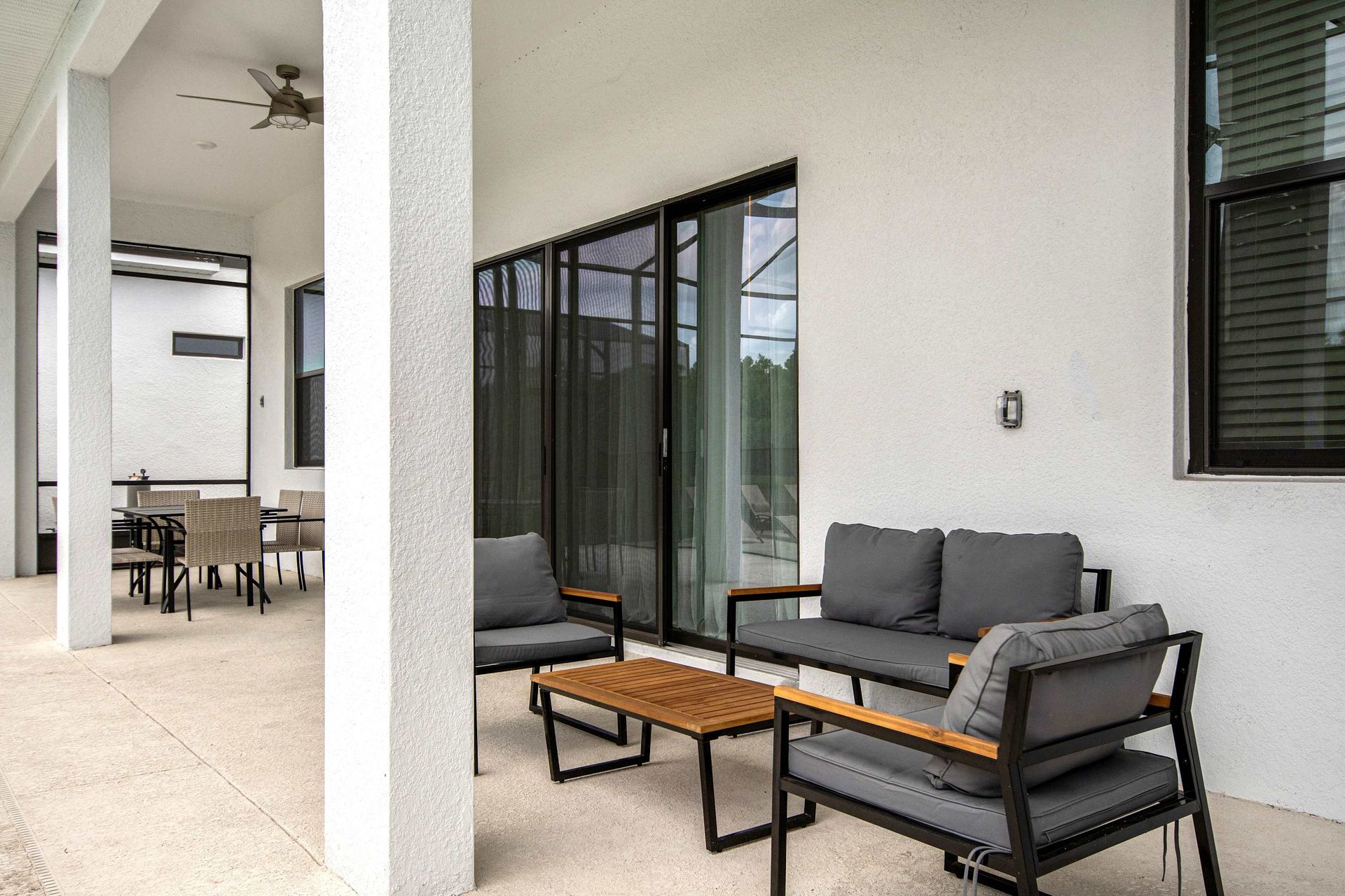 Stylish covered patio with modern seating, perfect for relaxing or outdoor dining
