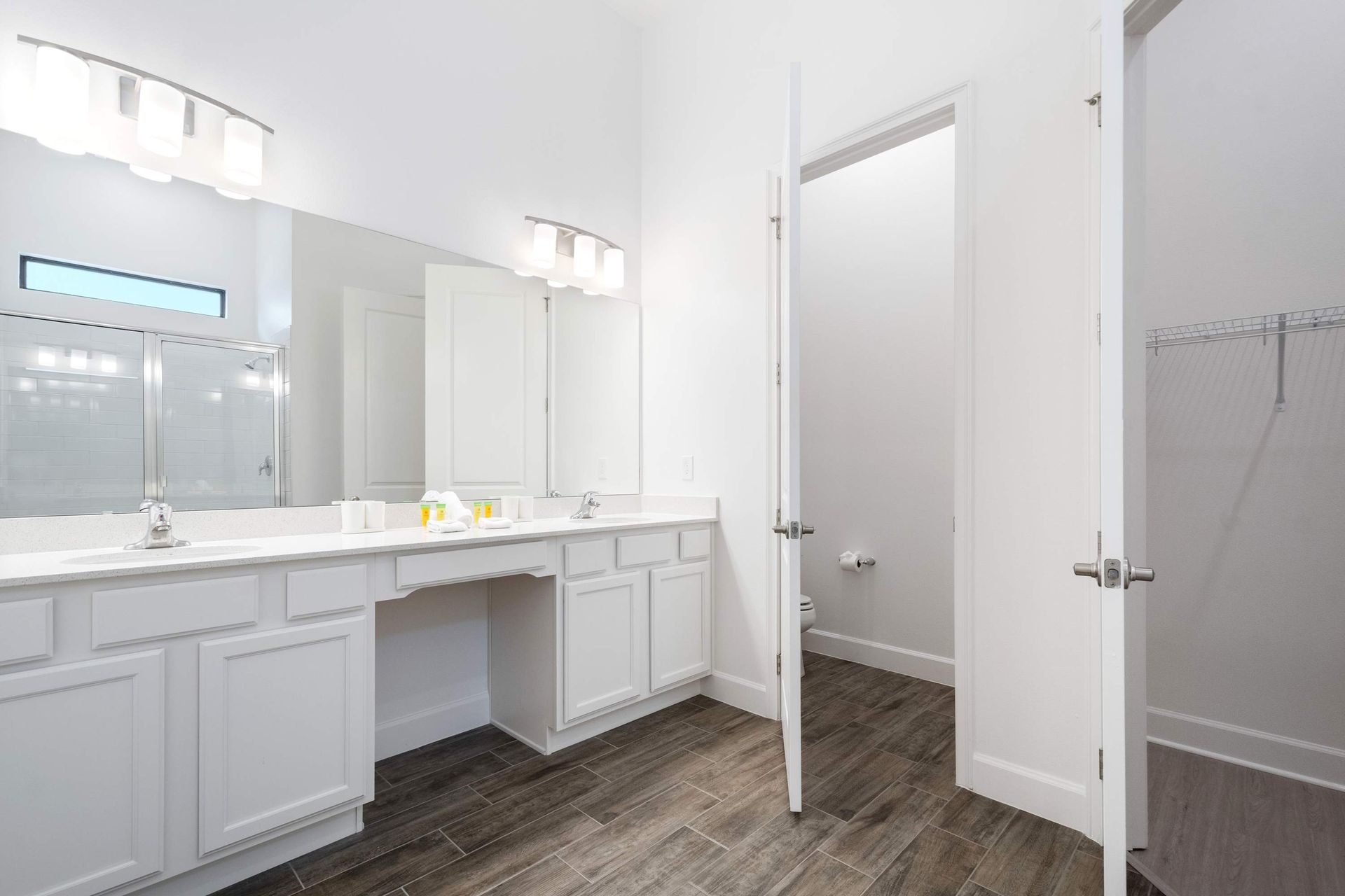 Spacious ensuite bath with double vanities, walk-in closet, and modern finishes
