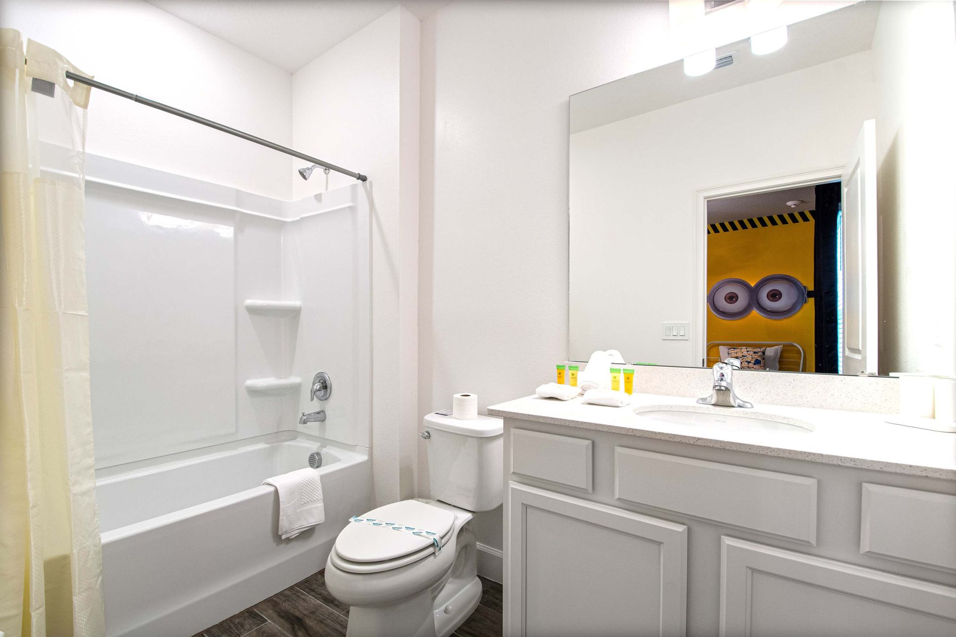 Modern full bathroom with bright white finishes, tub-shower combo, and essentials
