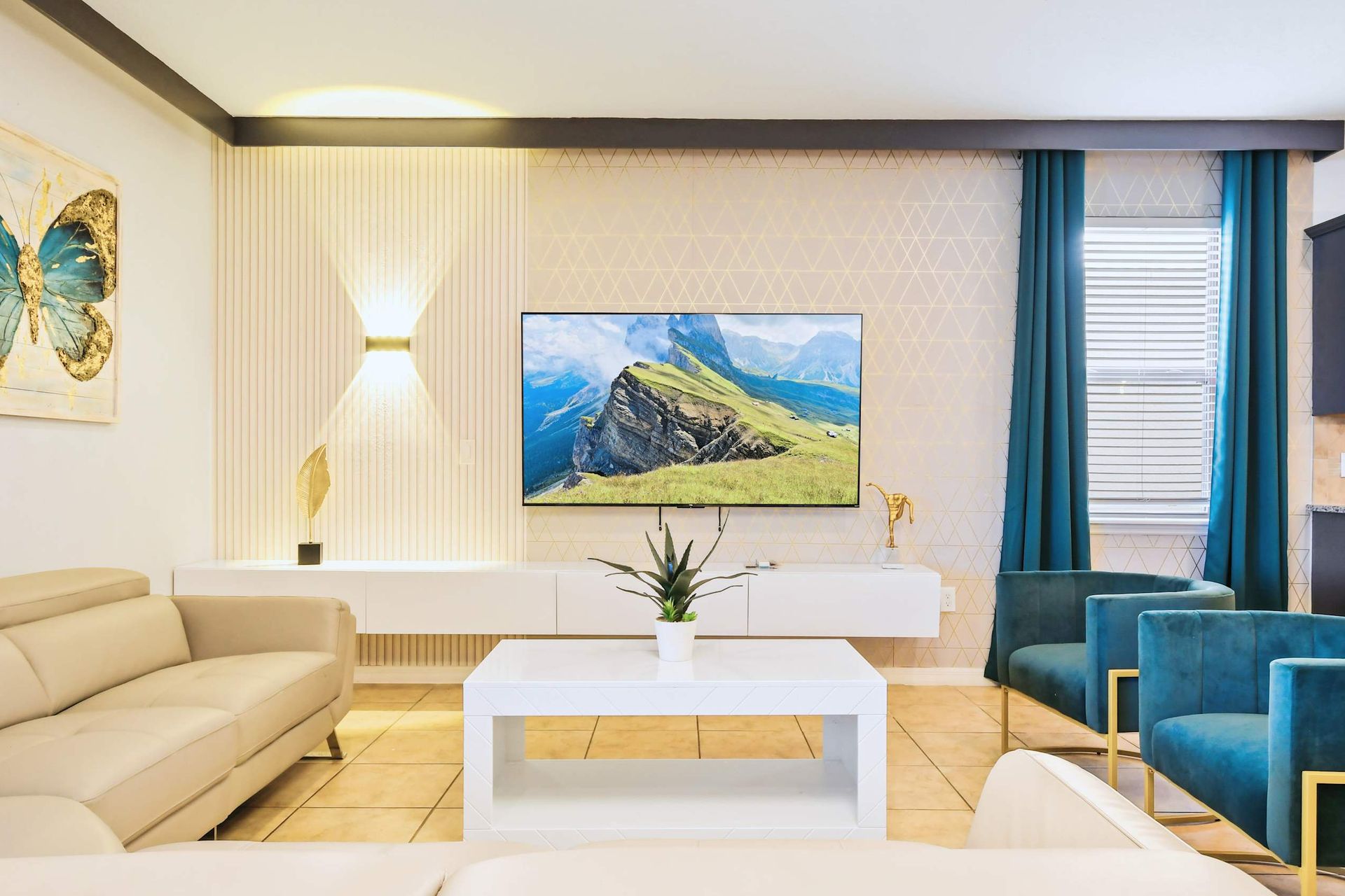 Chic living room with modern decor, bold accents, and a sleek entertainment setup.
