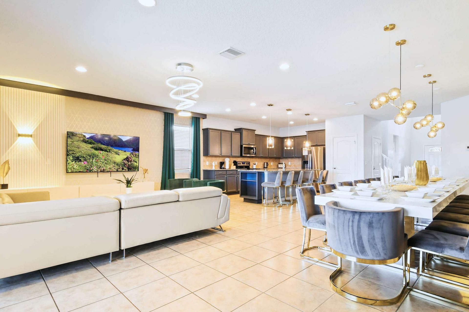 Expansive open-concept space with designer furnishings, gourmet kitchen, and grand dining.
