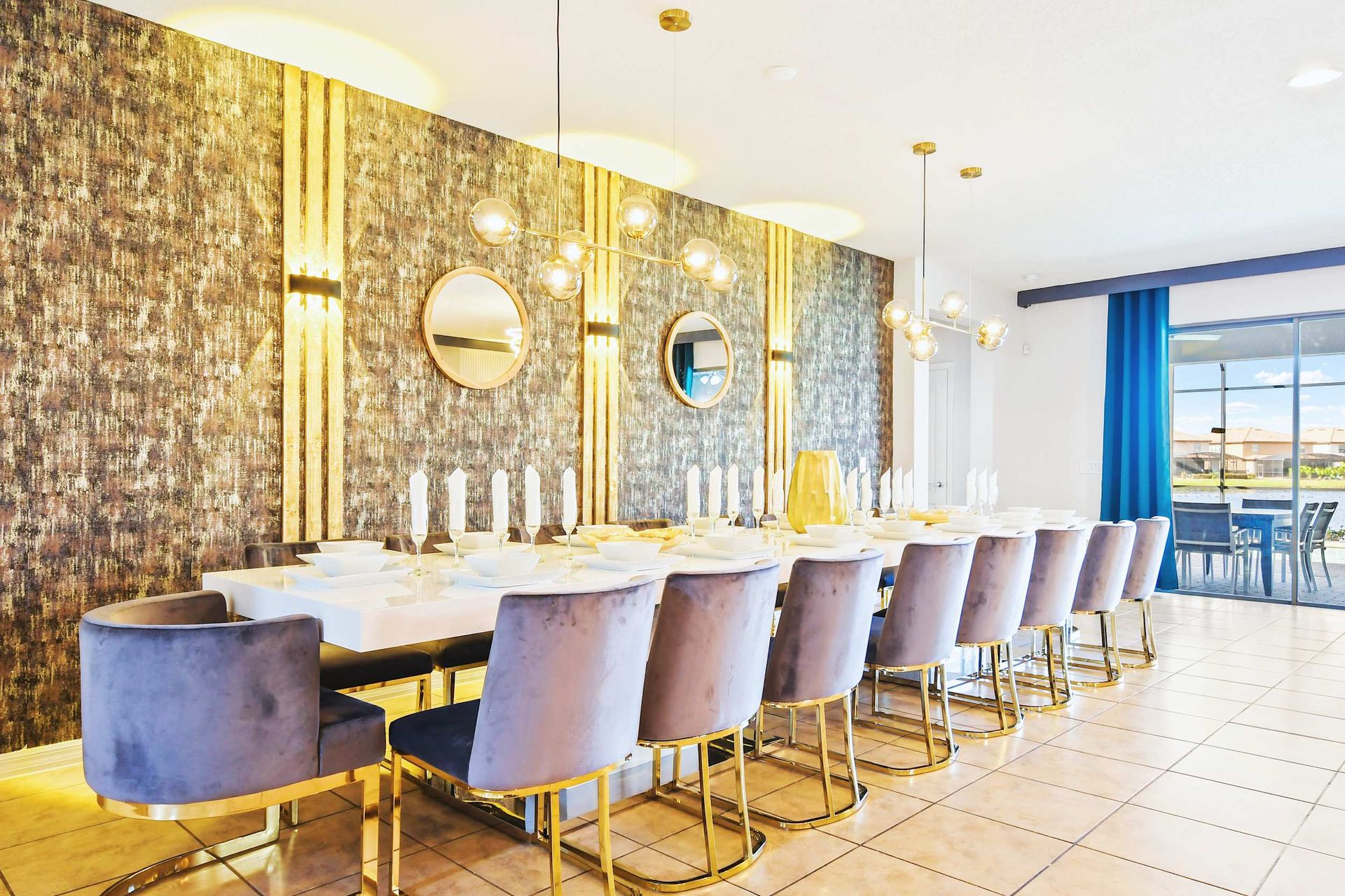 Stunning formal dining room with velvet seating, gold accents, and elegant lighting.

