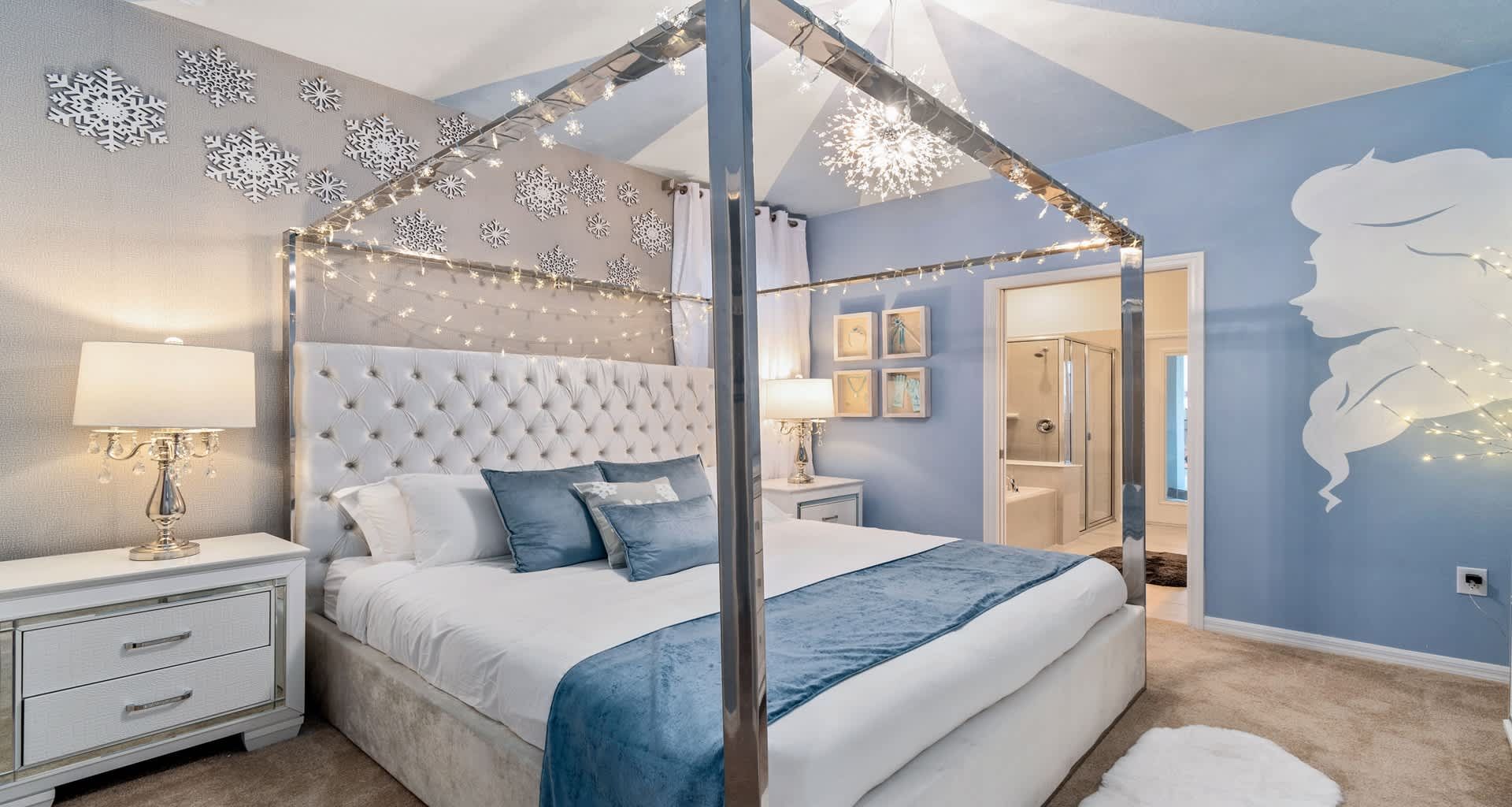 Serene blue bedroom with canopy bed, twinkling lights, and elegant snowflake accents!
