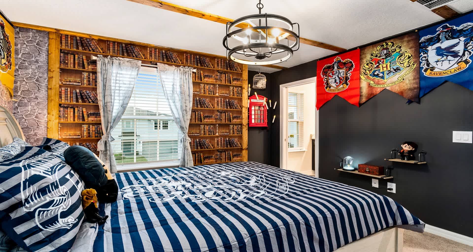 Wizarding World bedroom with all four house banners, book wall, and spellbinding decor!
