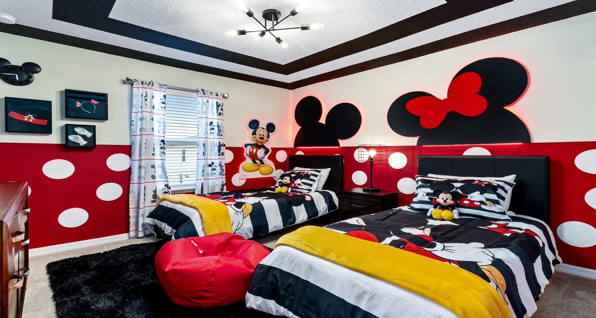 Whimsical Mickey & Minnie room with bold colors, twin beds, and pure magic!
