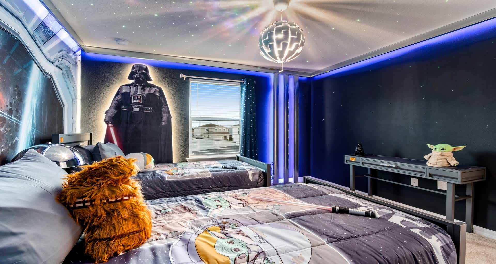 Star Wars galaxy room with twin beds, glowing lights, and Darth Vader watching!
