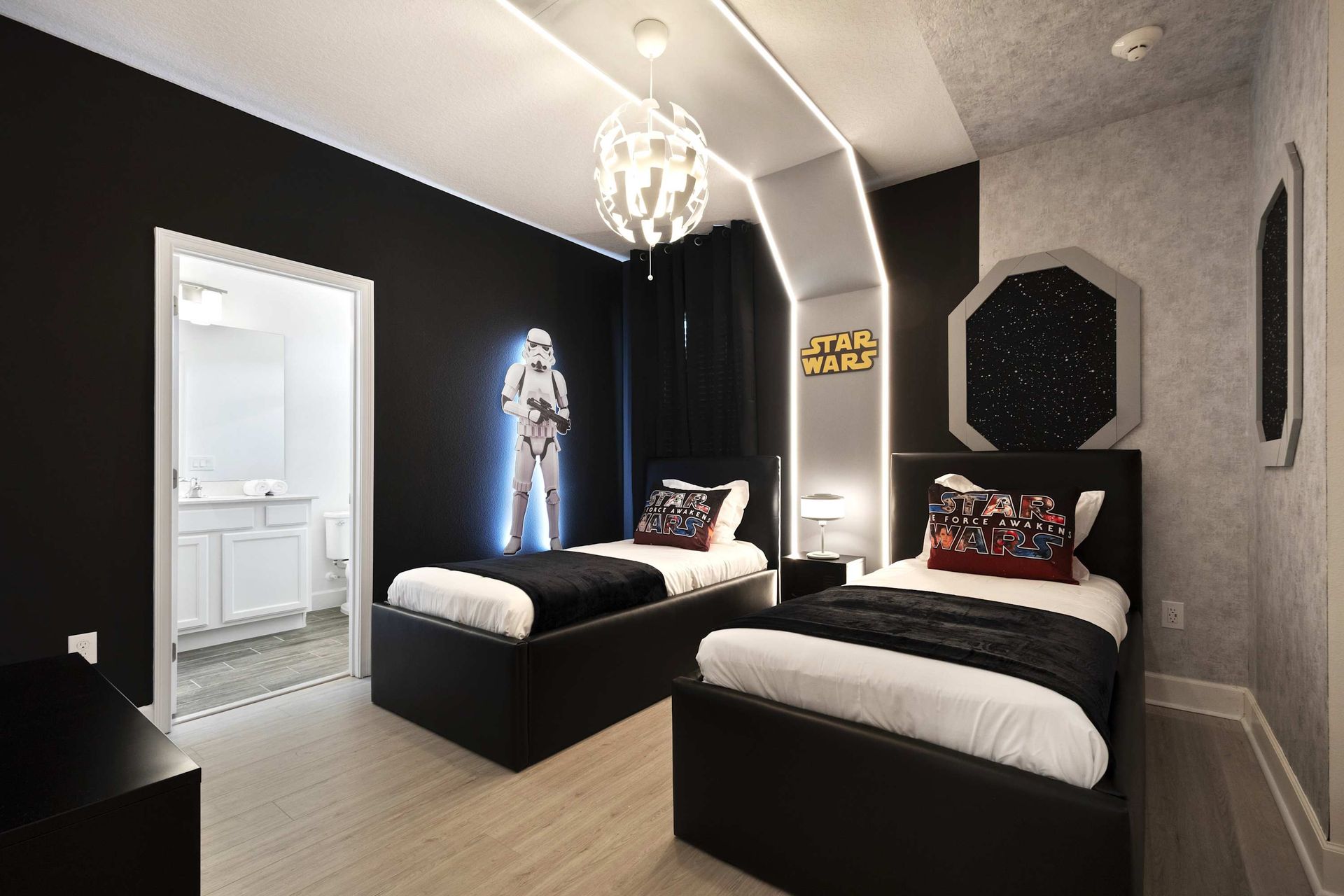Twin beds in a sleek STAR WARS room with neon light and Stormtrooper. 
