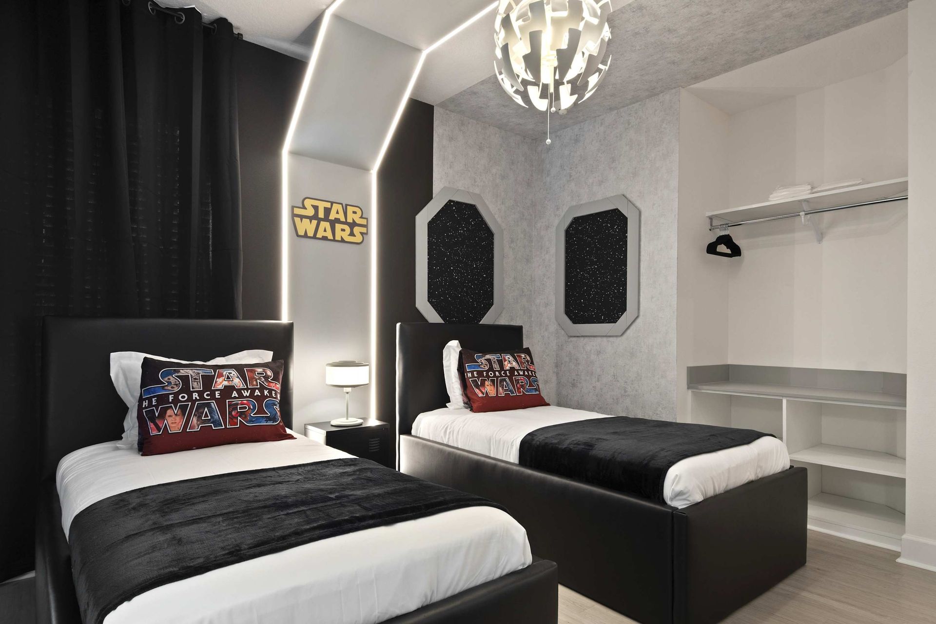 Sleek twin beds in a monochromatic STAR WARS themed room. 