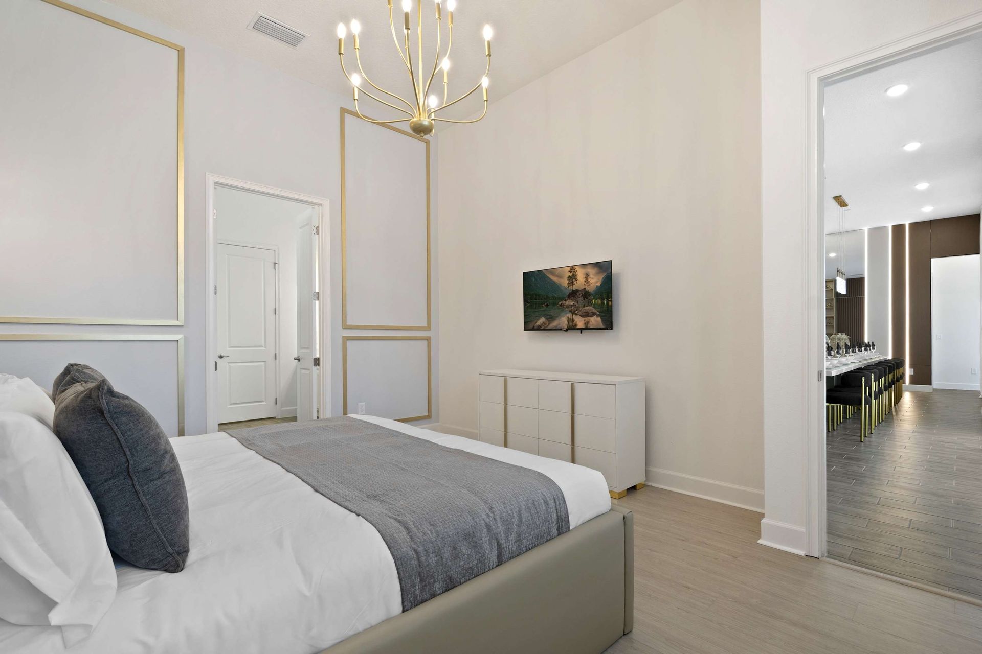 High ceilings, gold trim, and a stunning chandelier define this chic suite.