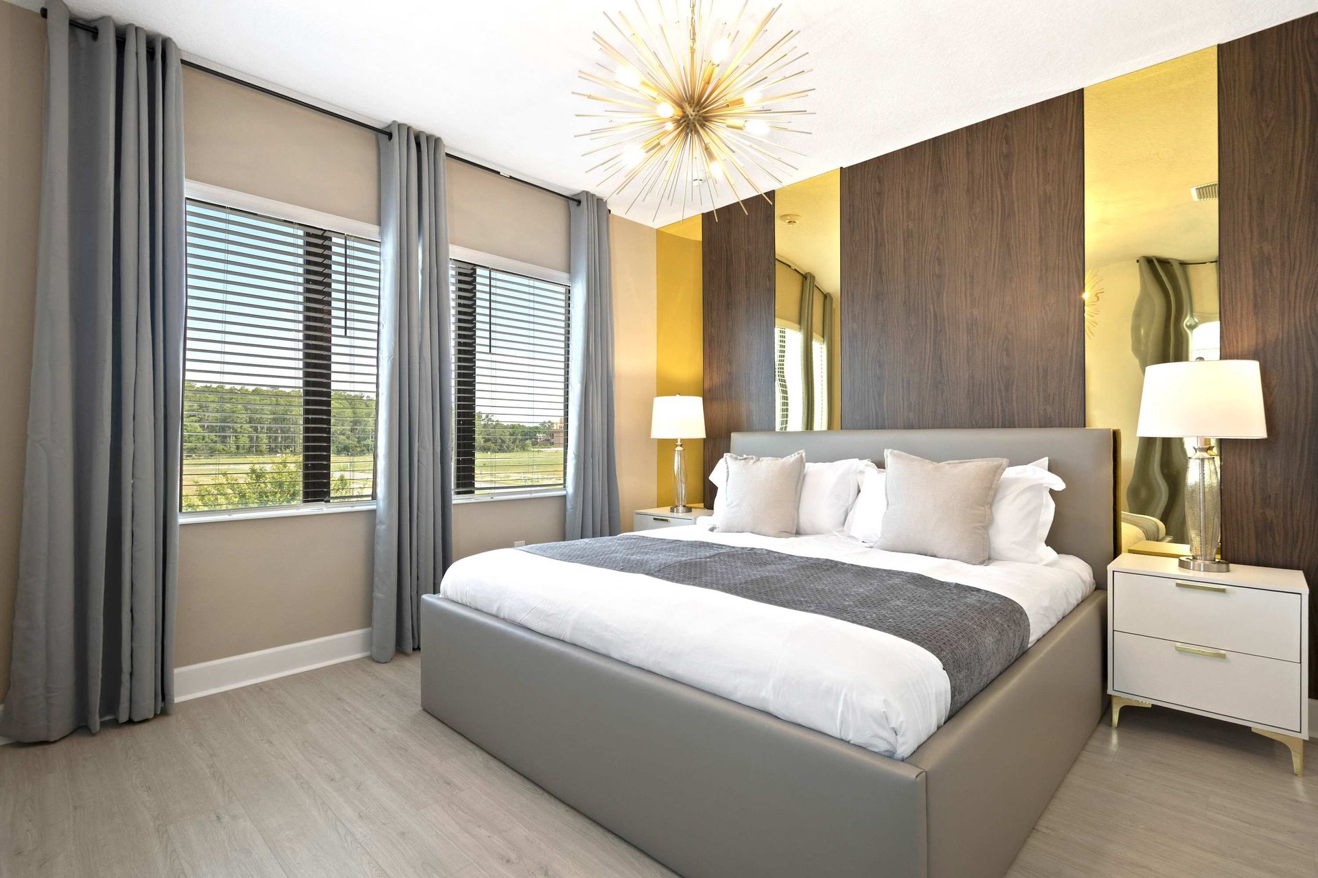 Sleek modern design with gray, gold, and dark wood accents. 