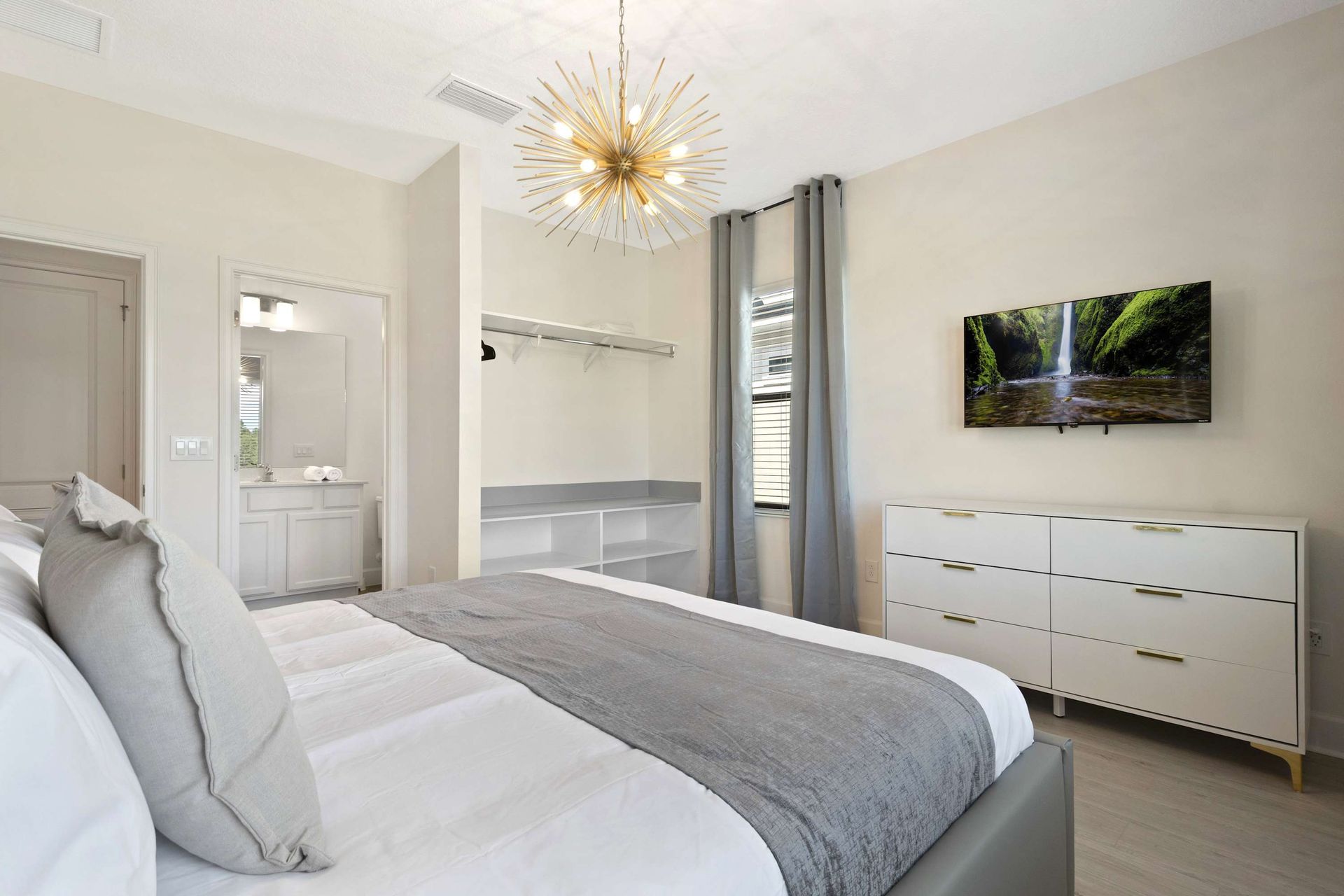 Modern white and gray aesthetic with open closet and ample storage.