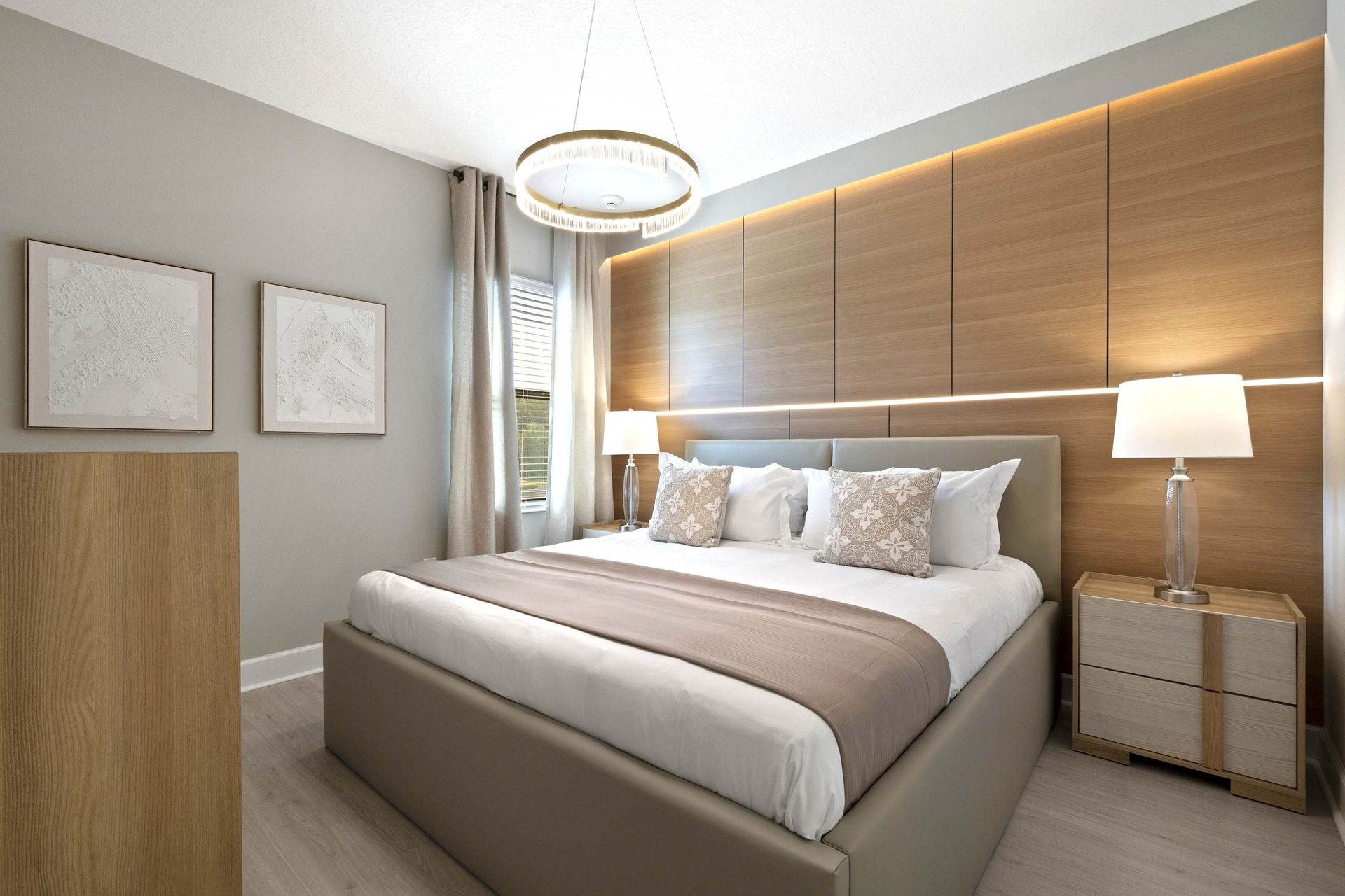Custom wood accent wall with soft LED lighting and chic queen bed.