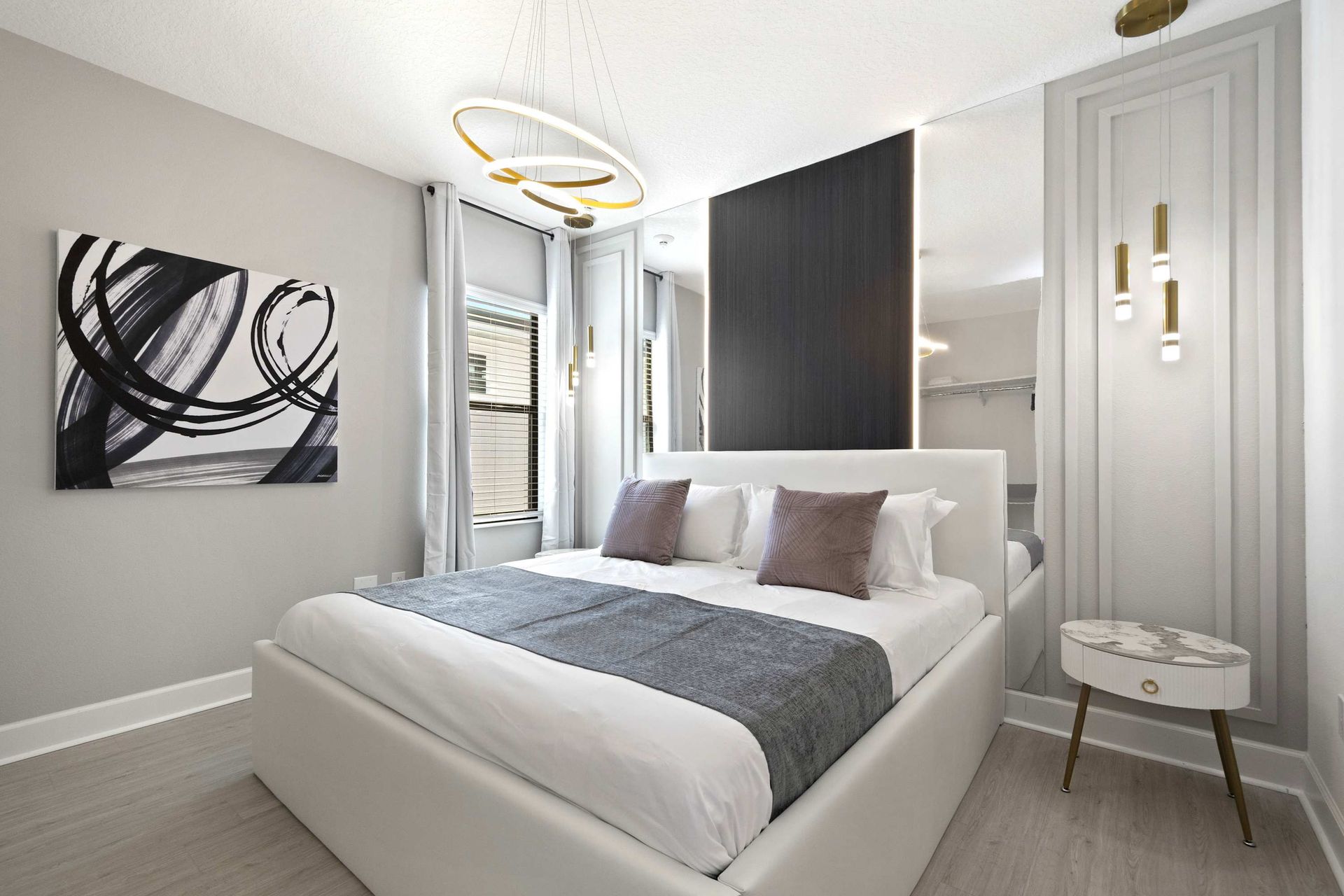 Monochromatic King suite with modern art and designer lighting.