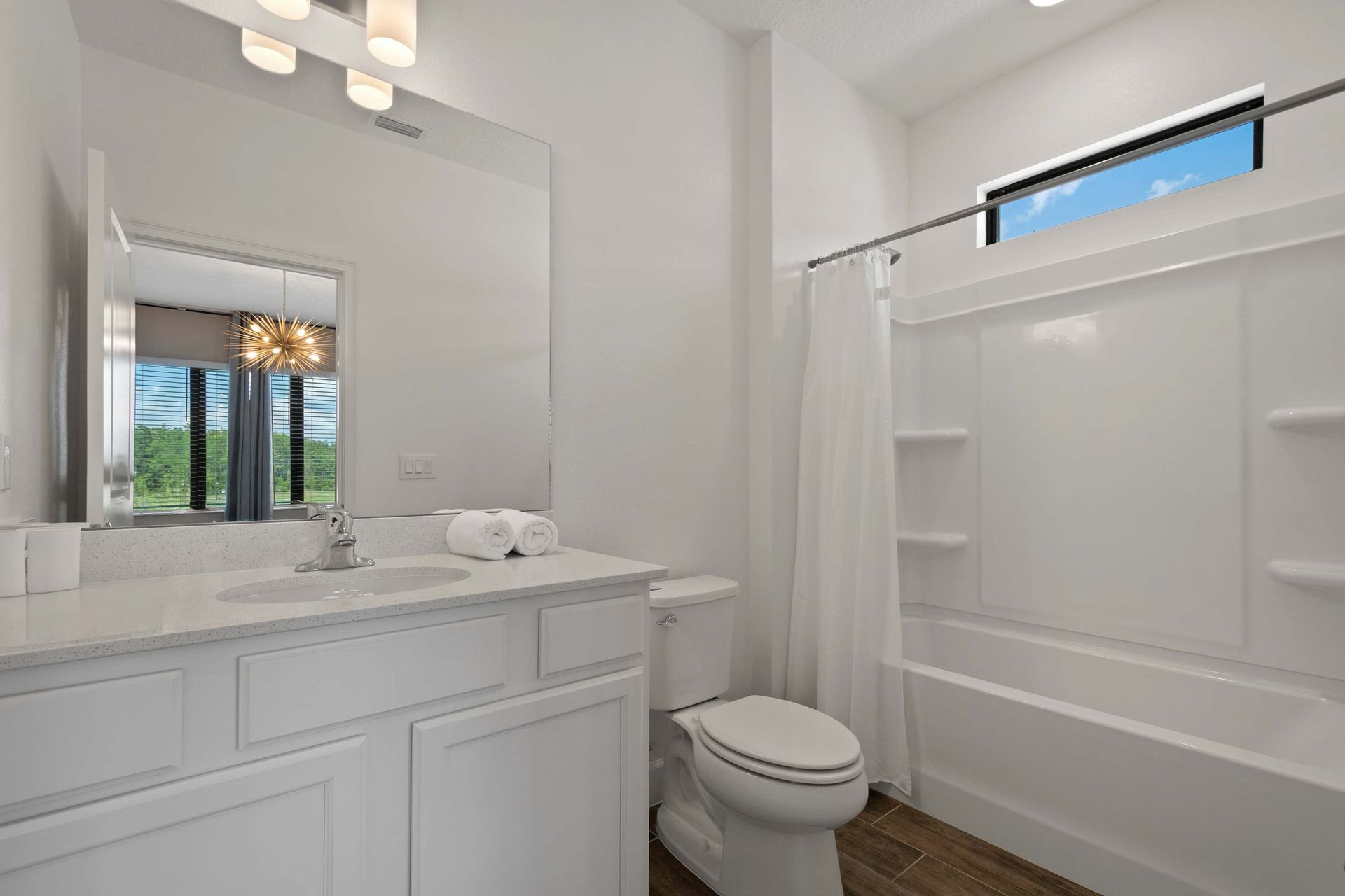 Clean full bath with dual vanity, tub/shower, and great natural light. 