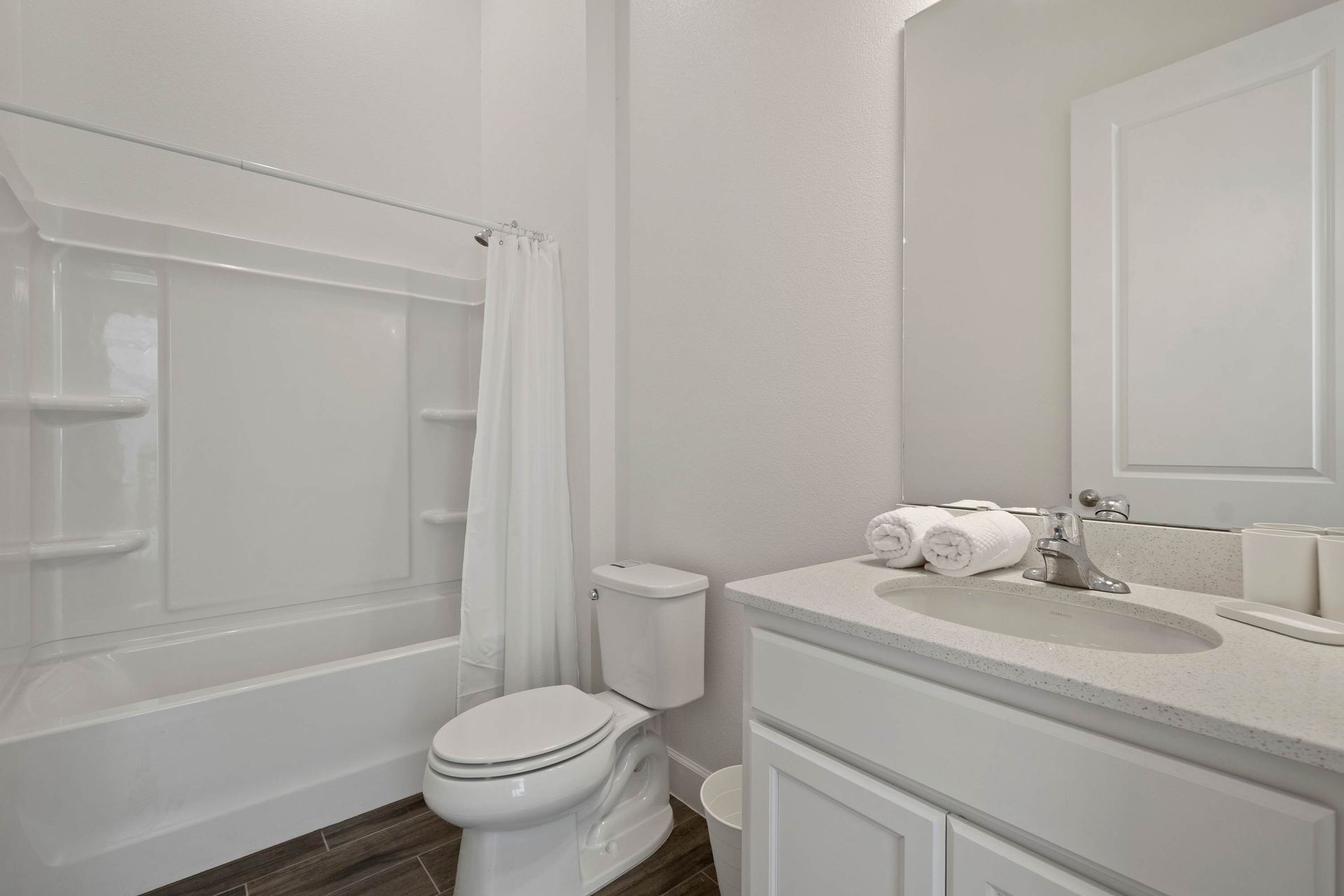 Bright, functional bathroom with ample vanity space and new fixtures.