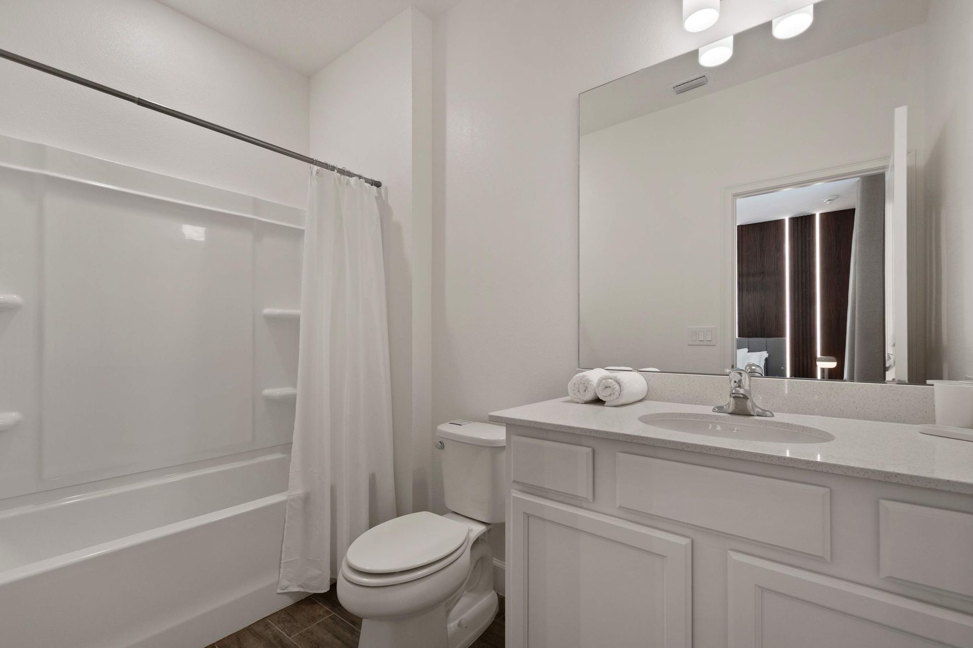 Clean white bathroom with tub and plenty of counter space. 