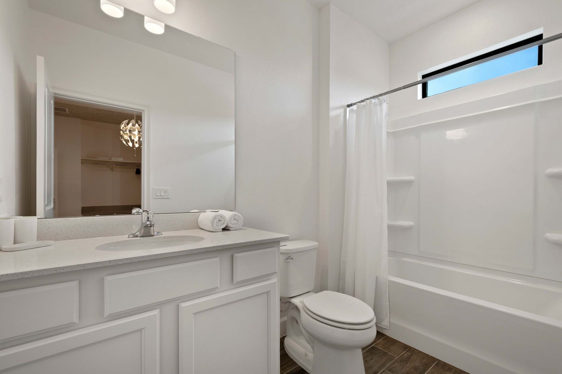 Clean full bath with ample counter space and natural light. 
