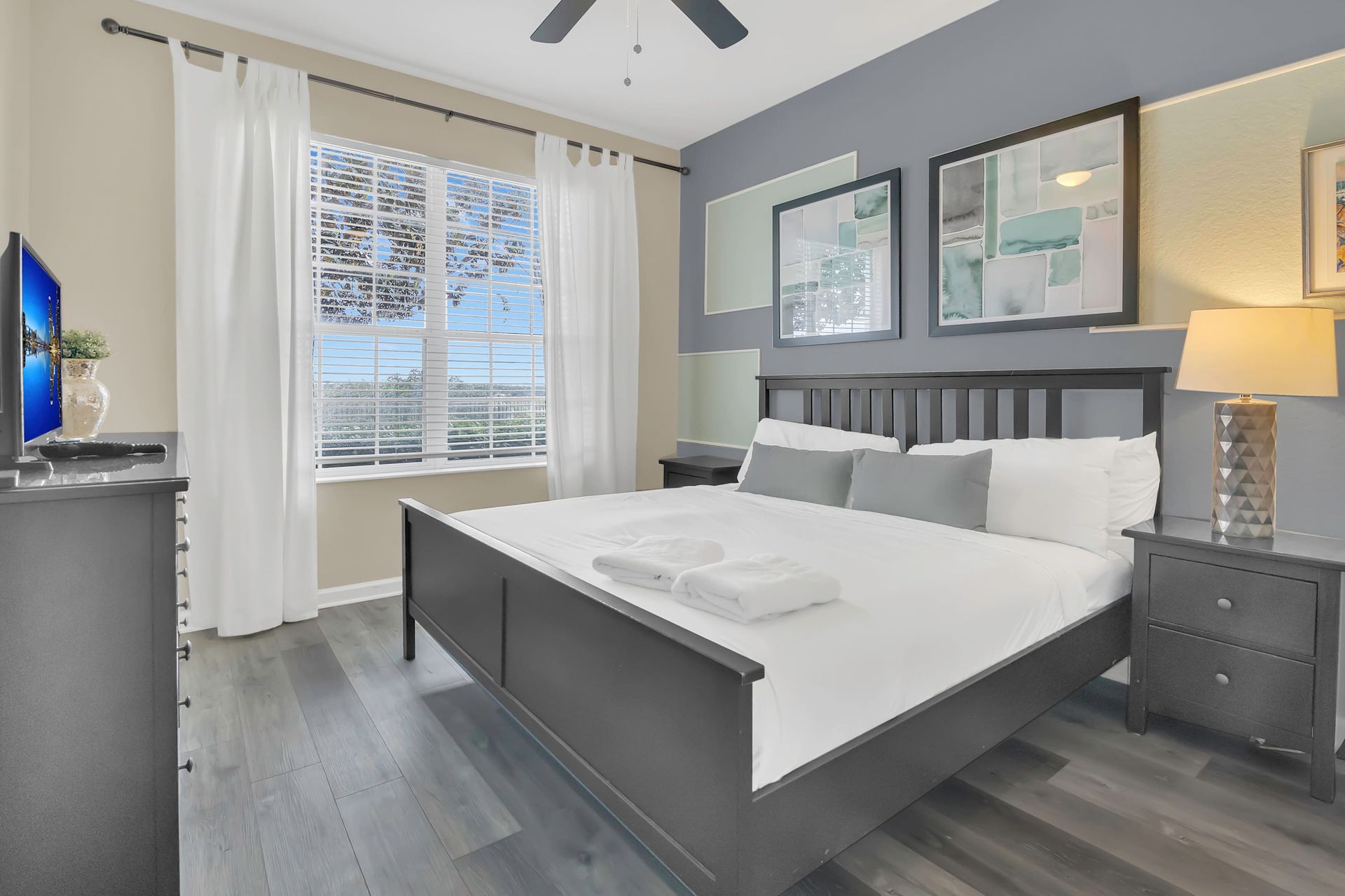 Plush king bed and ample natural light for a relaxing retreat. 