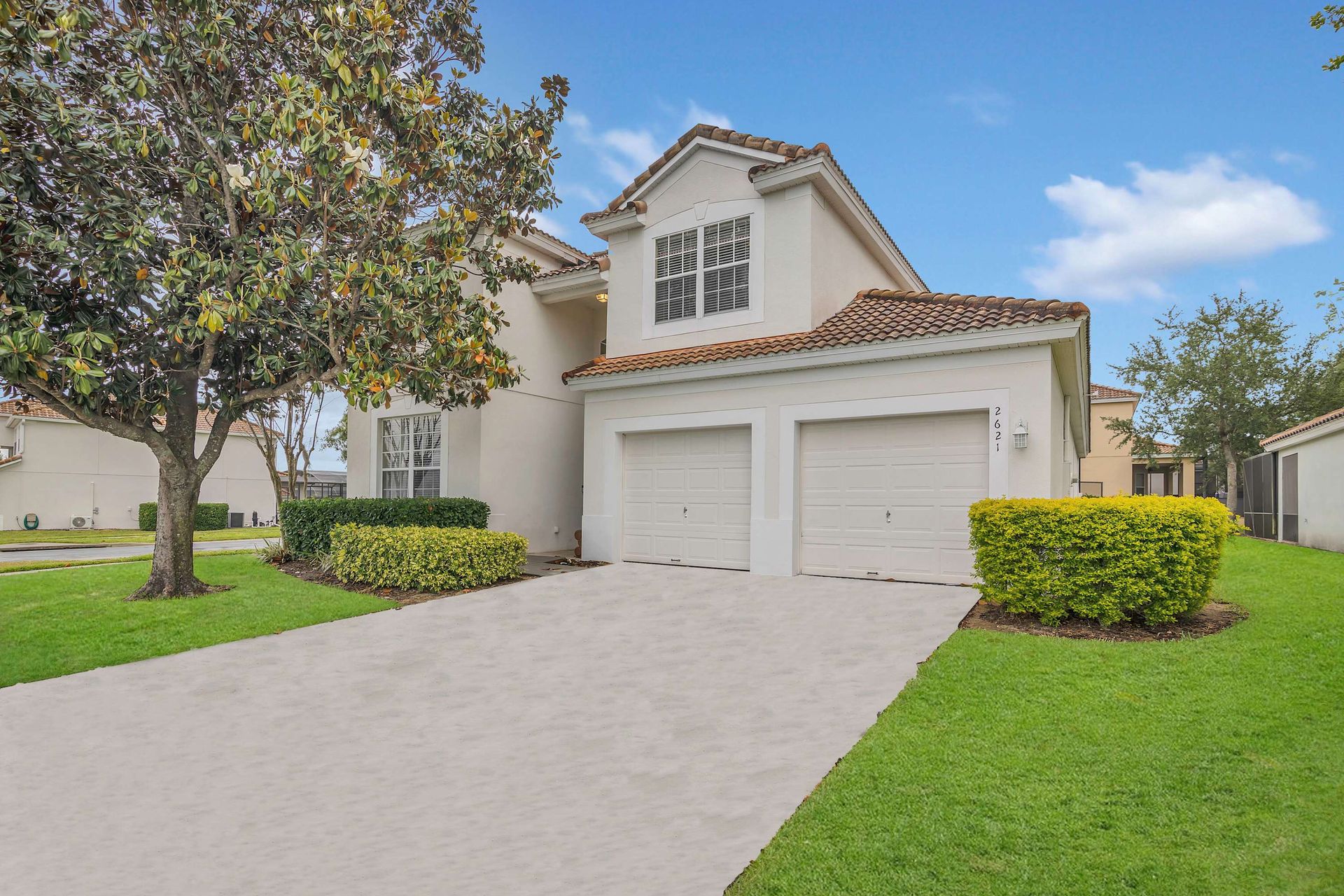 Great curb appeal with a bright facade and manicured landscaping.