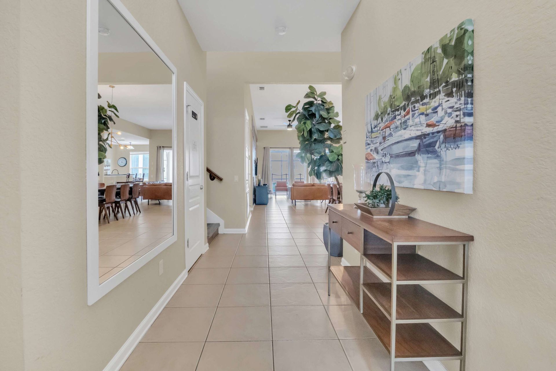 Welcoming hallway with modern console table and full-length mirrors.