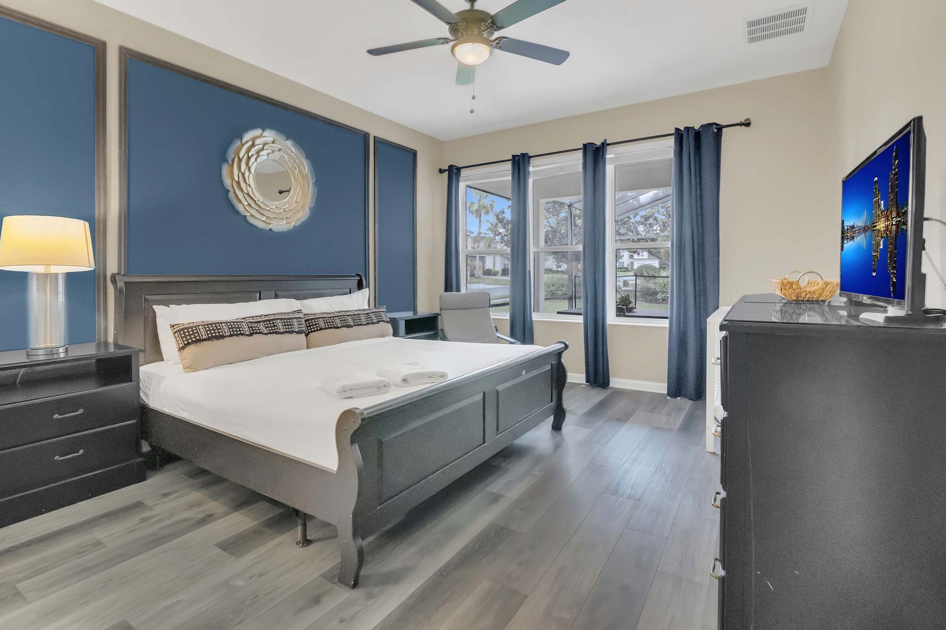 Stylish master bedroom with a king bed and wall-mounted TV.