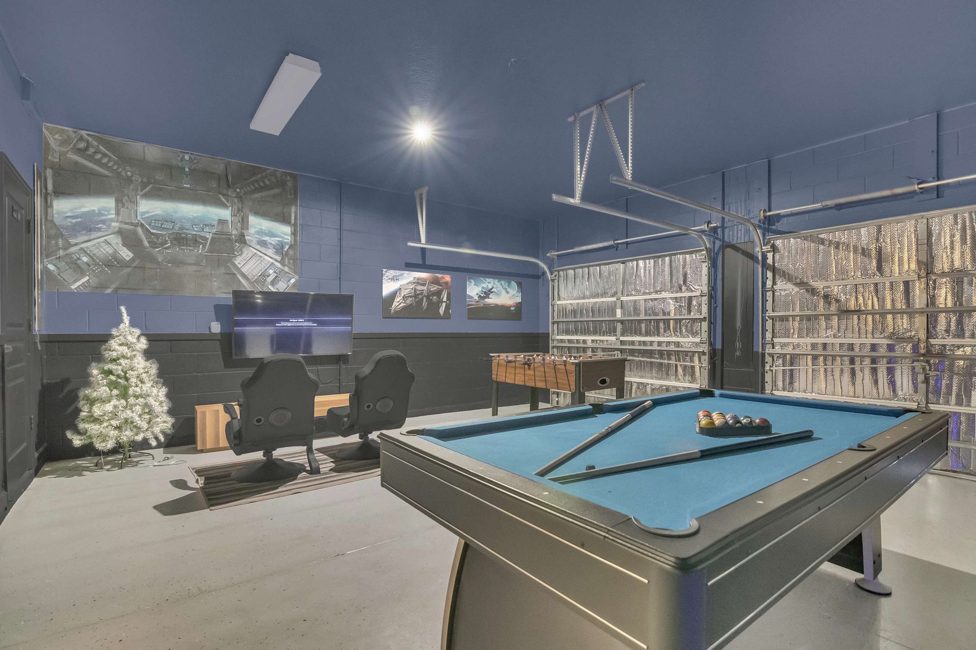 Ultimate game room with pool table, foosball, and racing simulators.