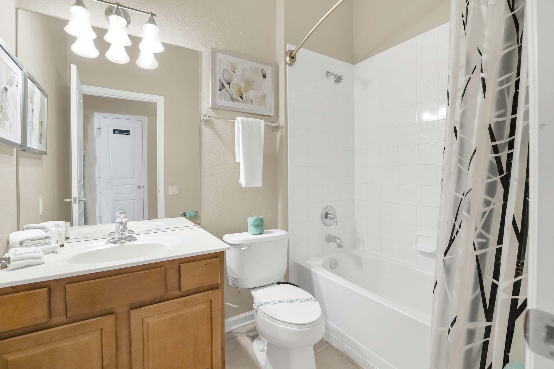 Full bath with tub, shower, and ample counter space. 