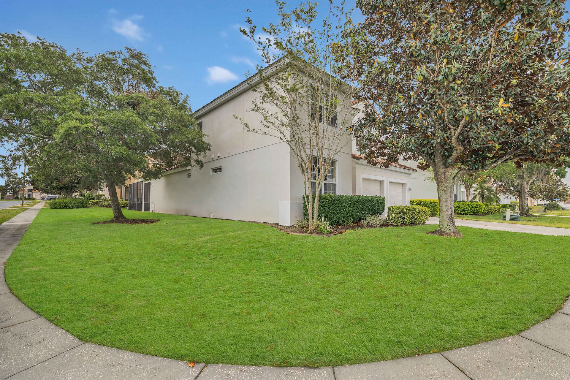 Lush green lawn and beautiful landscaping around the home.
