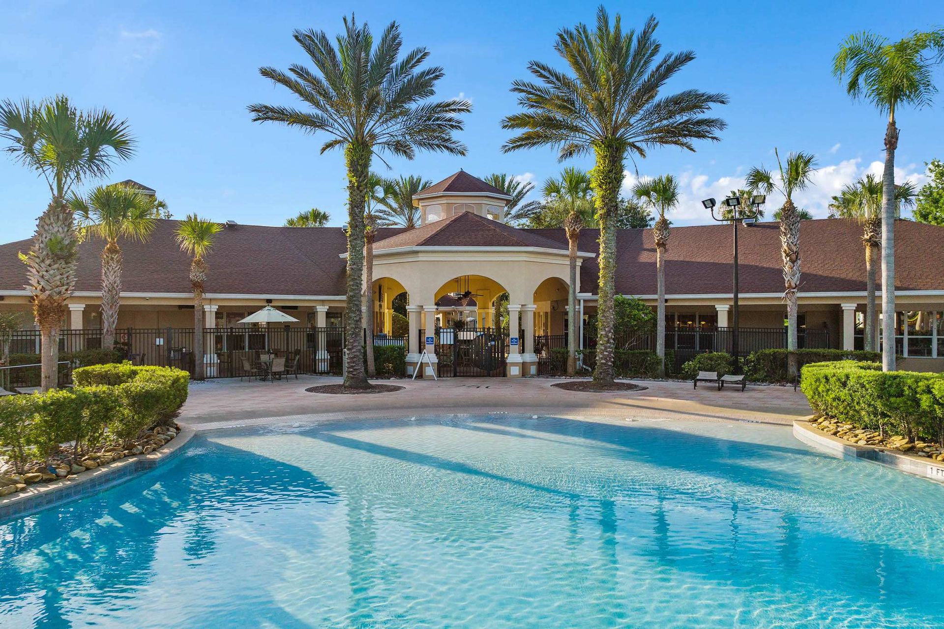 Crystal blue water and tropical palms at the clubhouse pool. 