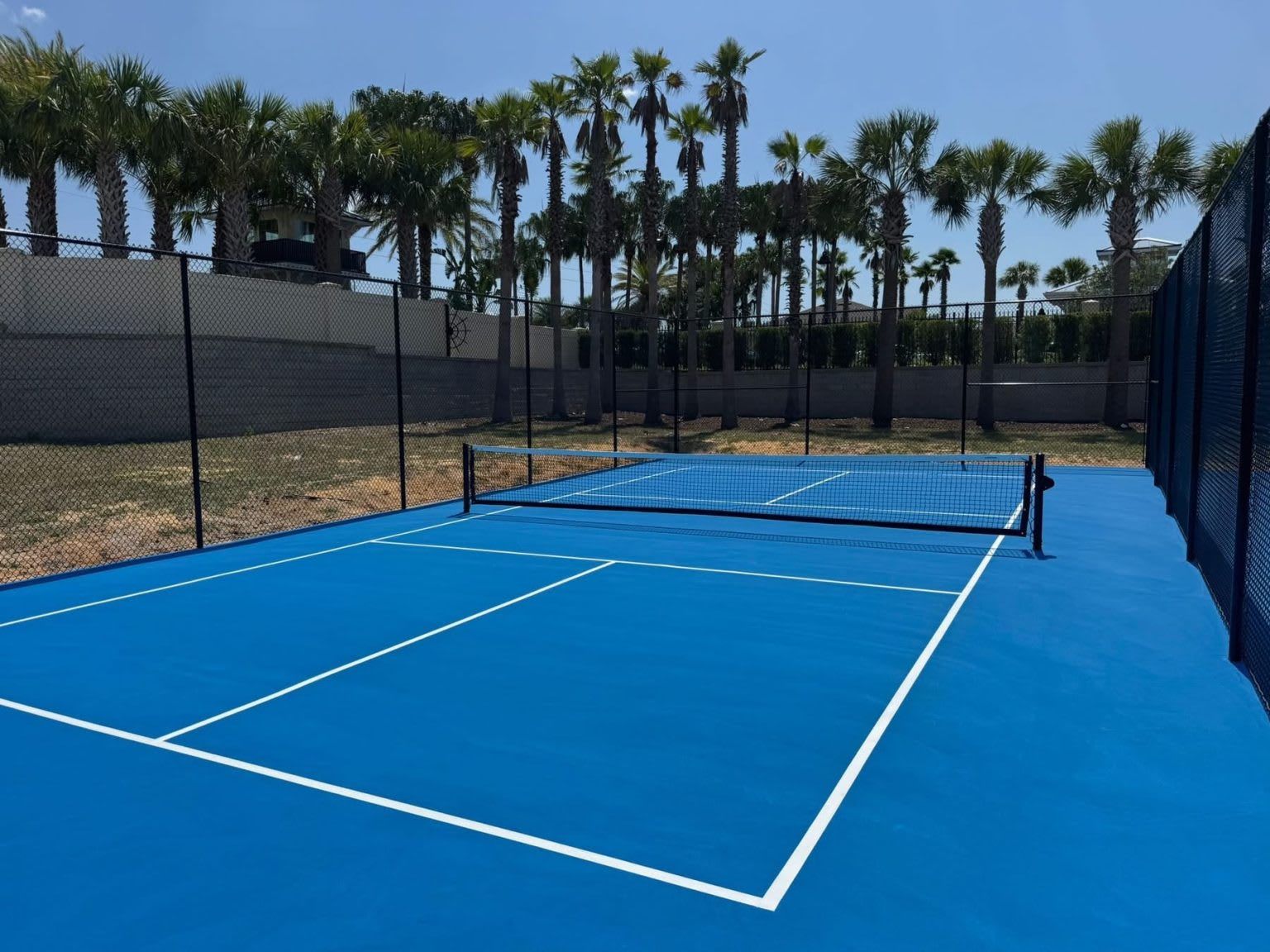 Sunny blue tennis and basketball courts for fun outdoor games and family activities
