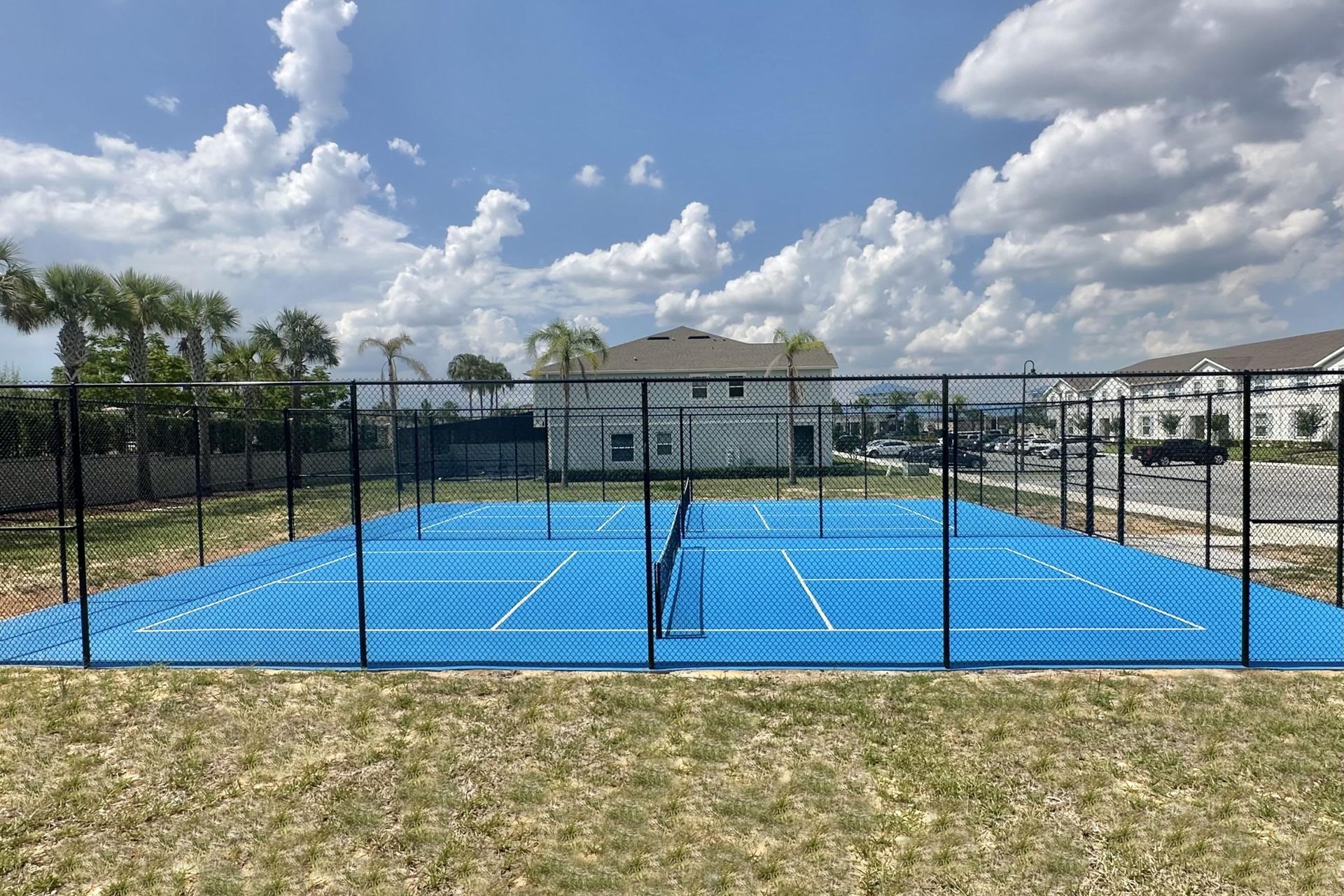 Sunny blue tennis and basketball courts for fun outdoor games and family activities
