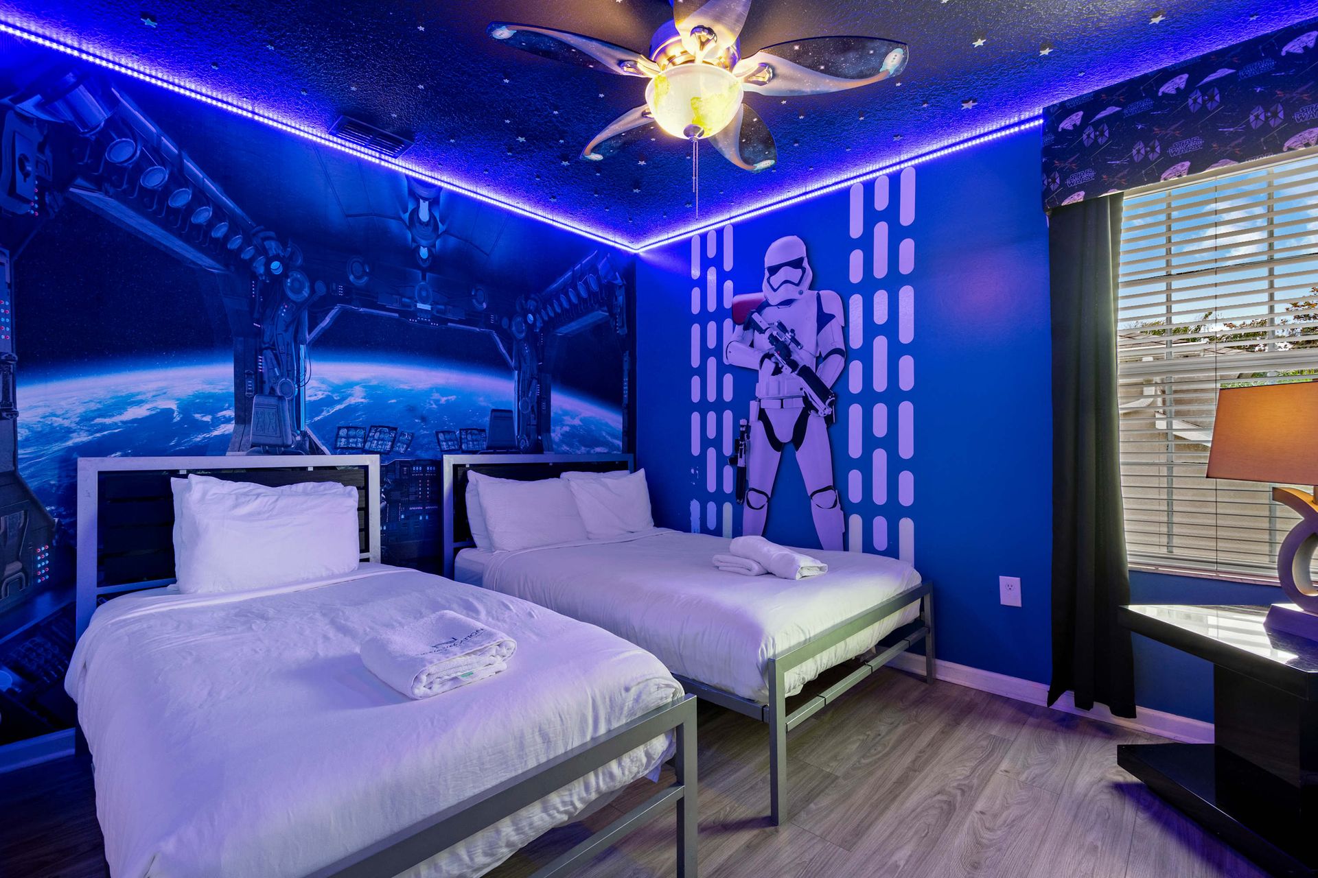 Galactic-themed twin room with LED lights, perfect for space adventure fans
