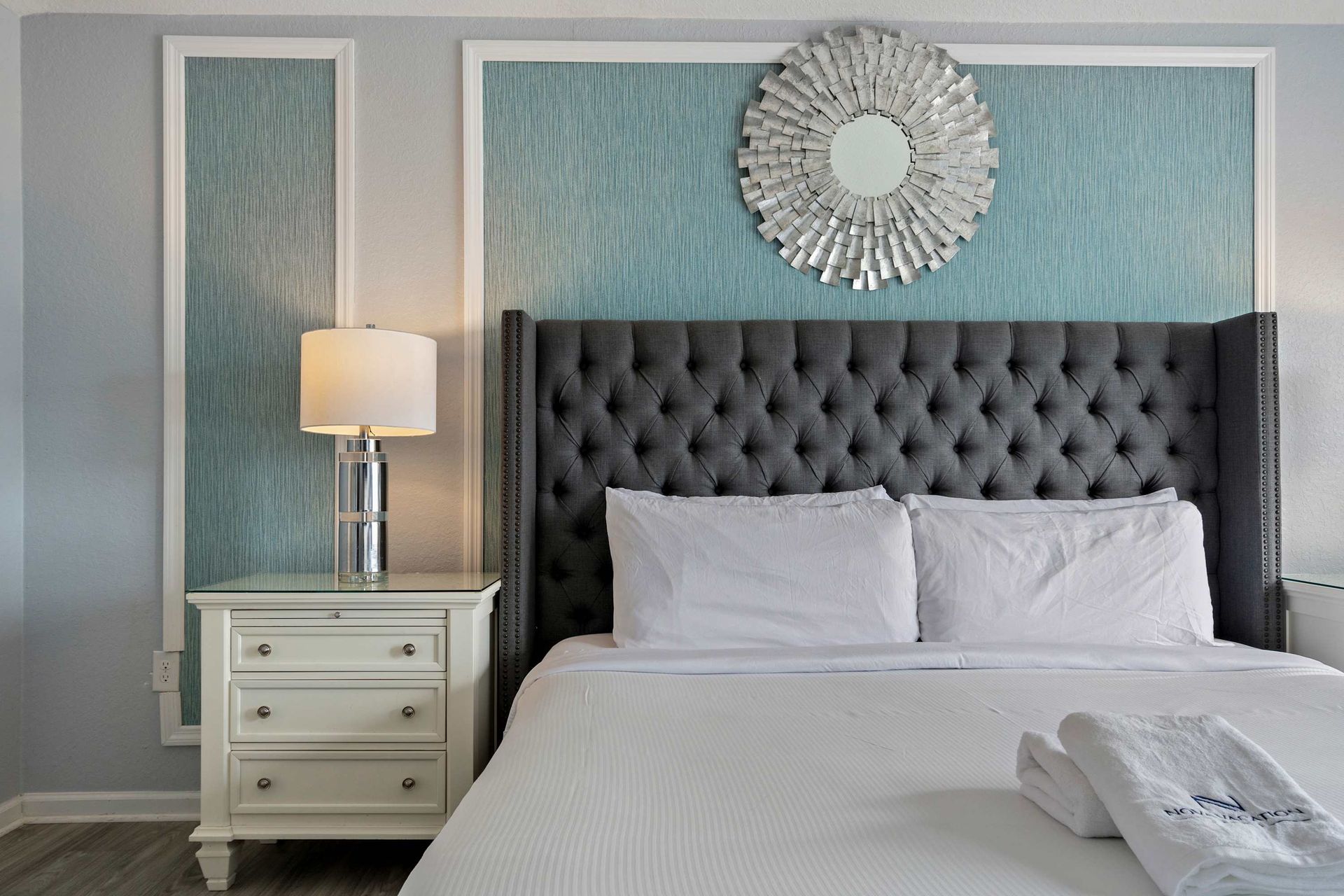 Spacious master suite with king bed, elegant accents, and a private crib area
