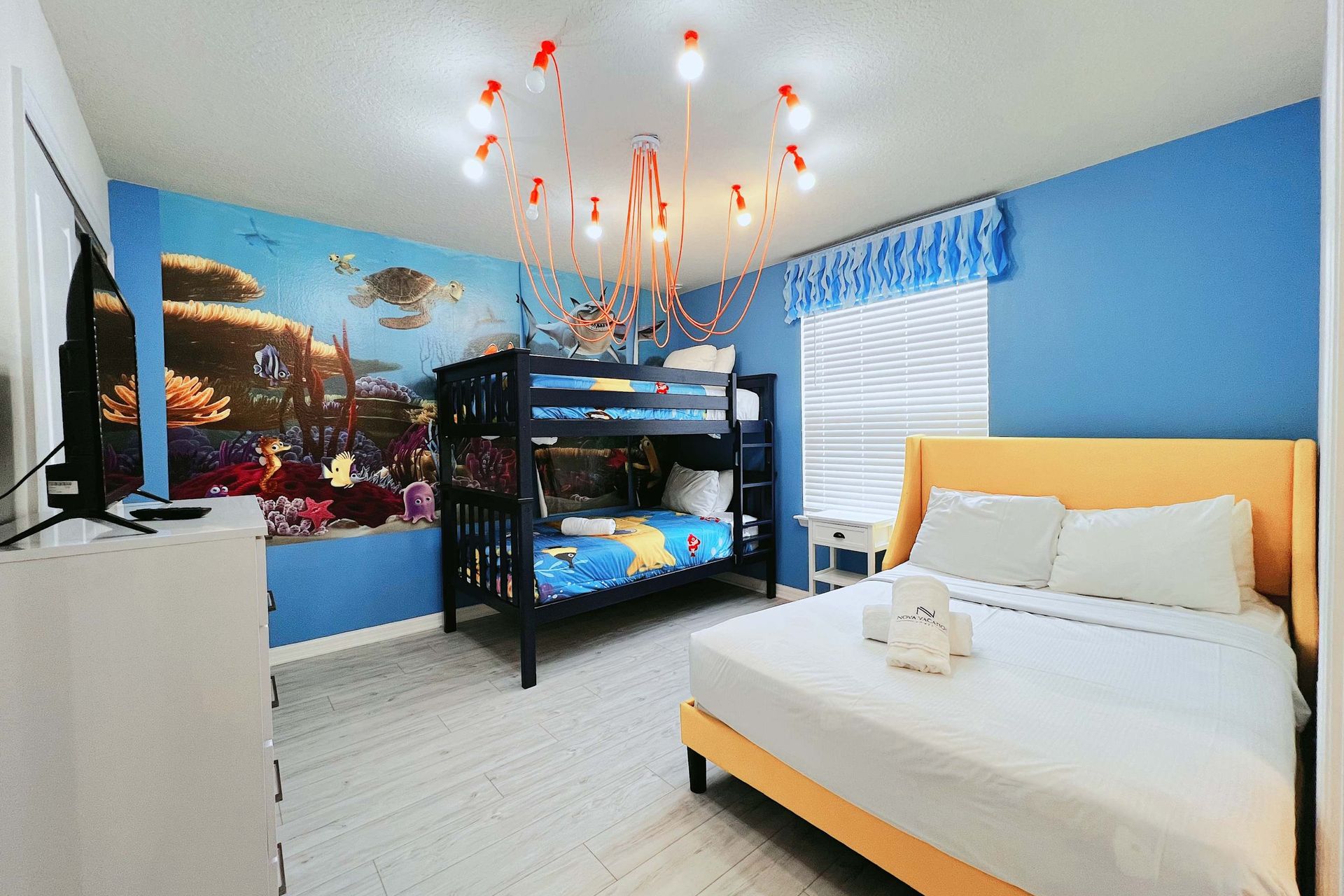 Modern cozy bedroom with bold orange accents, plush bedding, and stylish lighting
