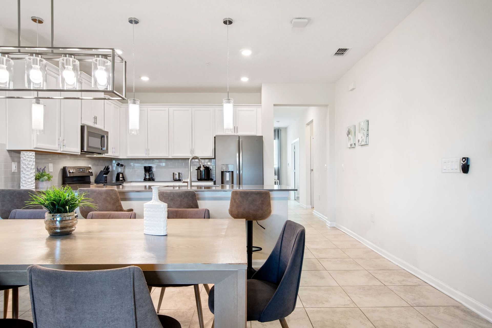 Chic dining area flows into a bright, fully equipped modern kitchen.