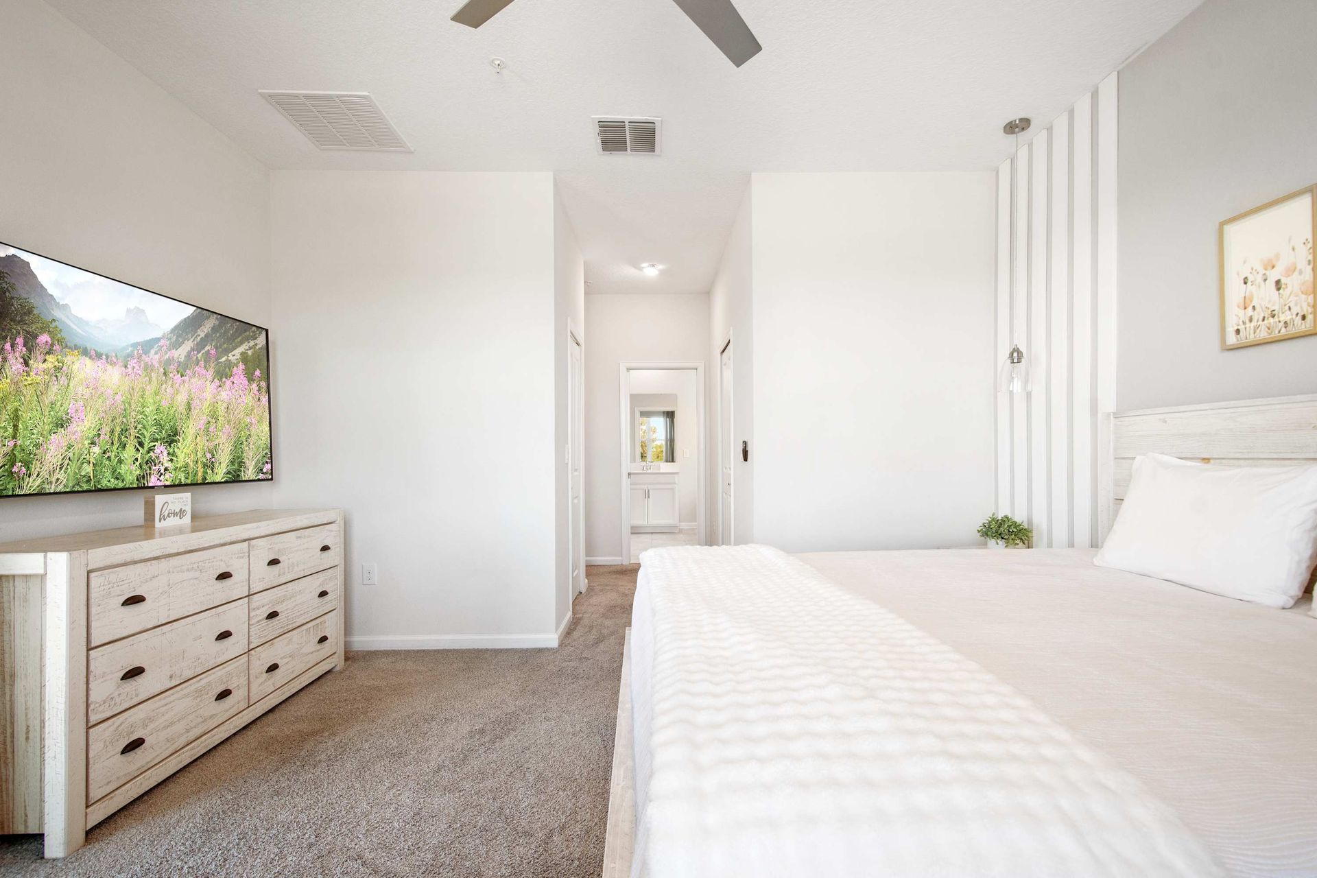 Bright, light-filled room with chic, rustic white furniture.