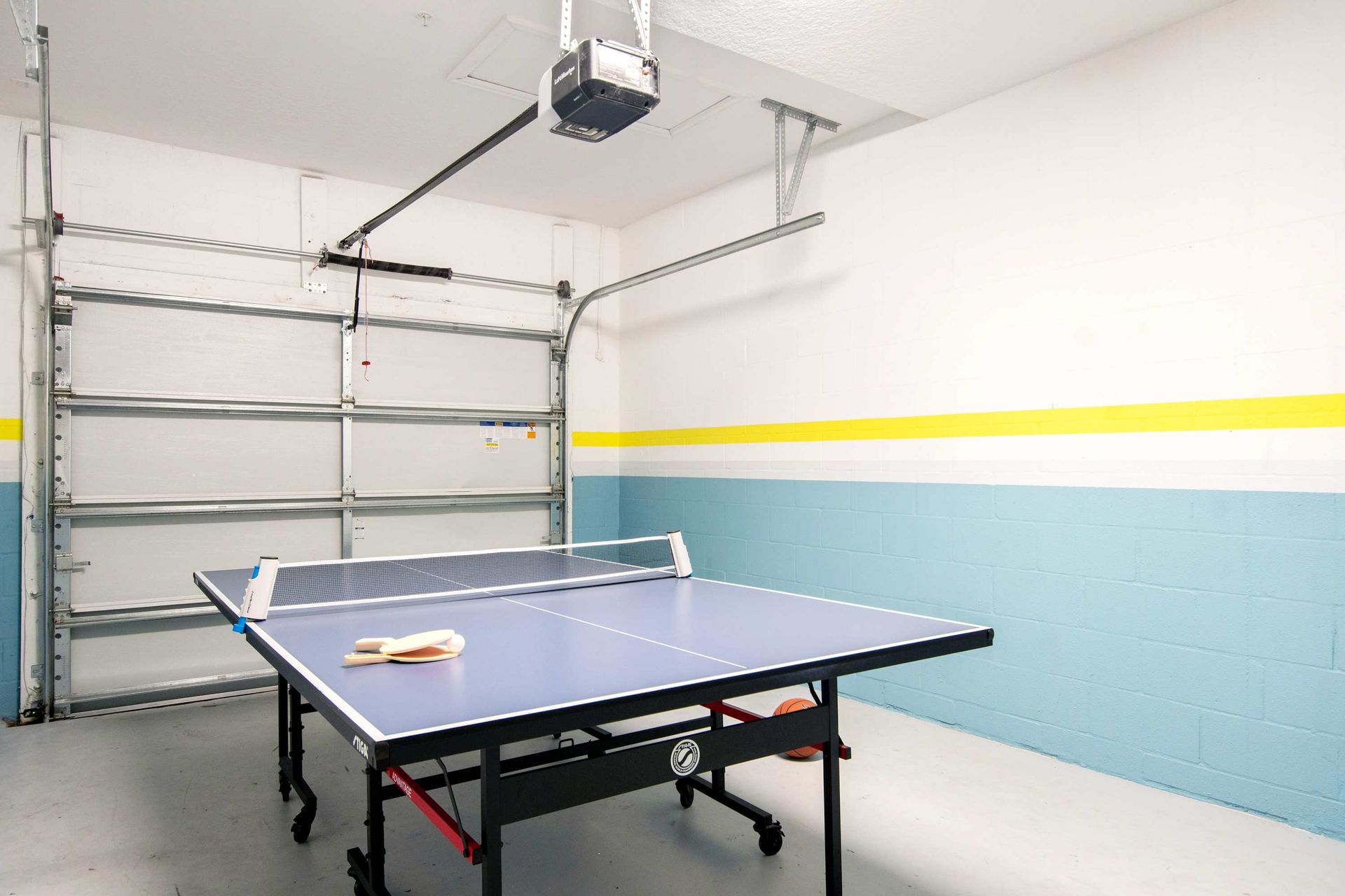 Fun for all! Ping pong and games in a clean garage conversion.