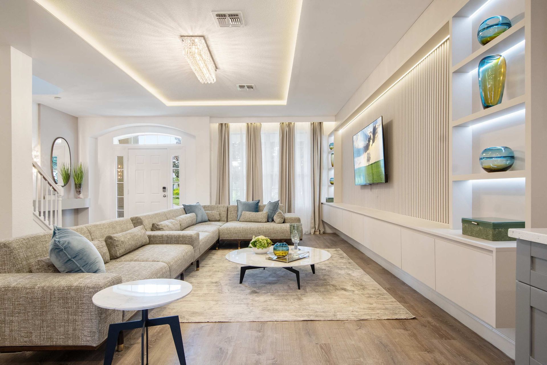 Modern luxury: clean lines, huge sectional, and gallery lighting. 