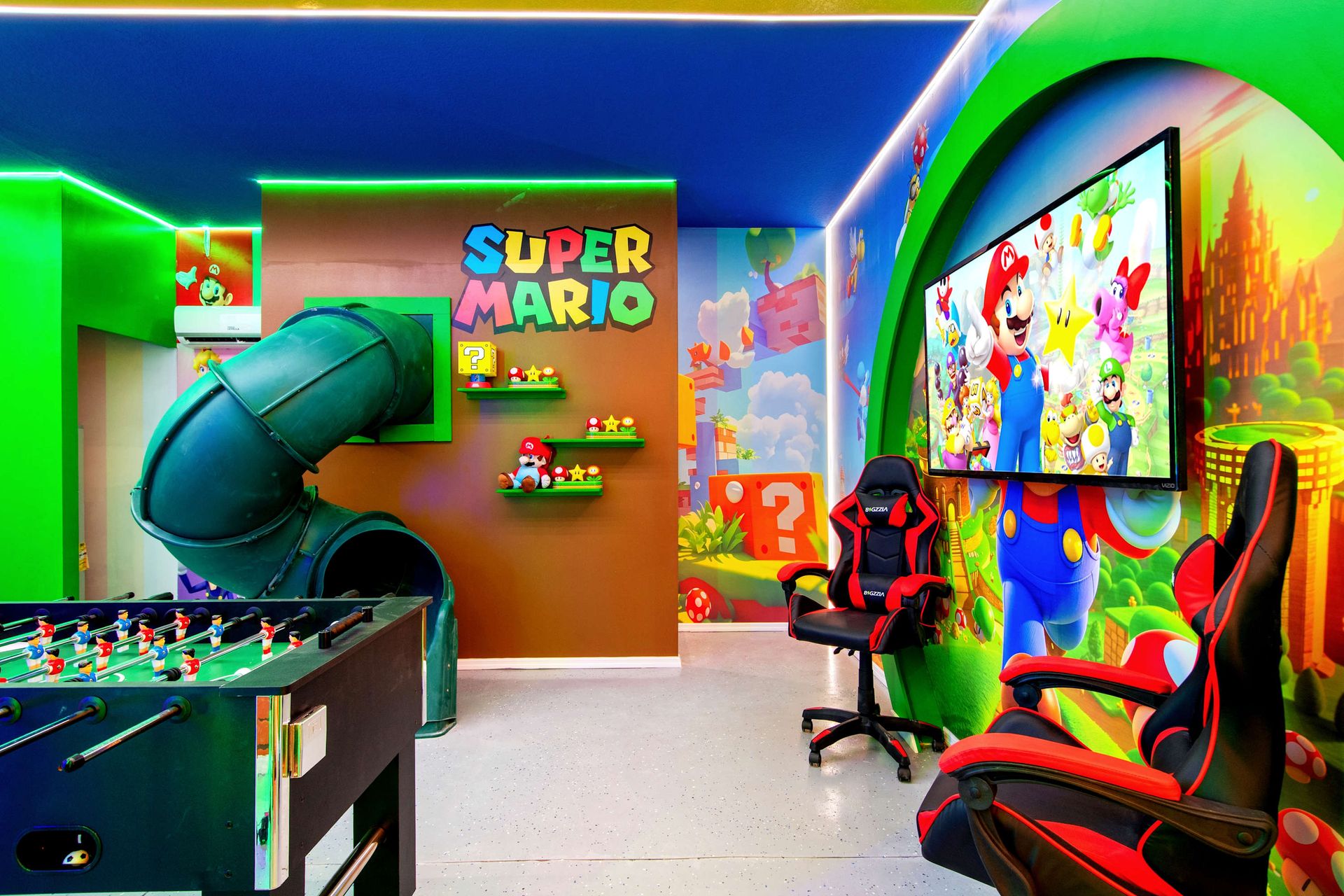 Super Mario fun: slide, foosball, and gaming chairs for the ultimate battle. 