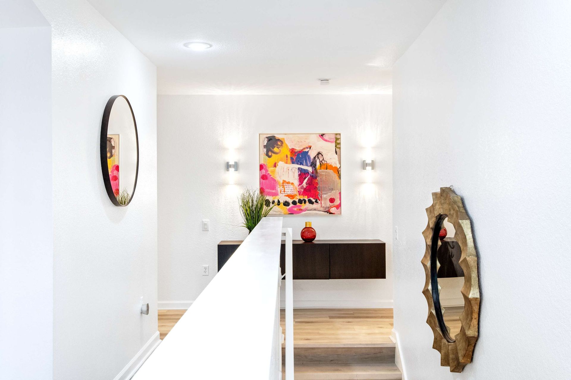 Stylish landing with pops of color and modern art. 