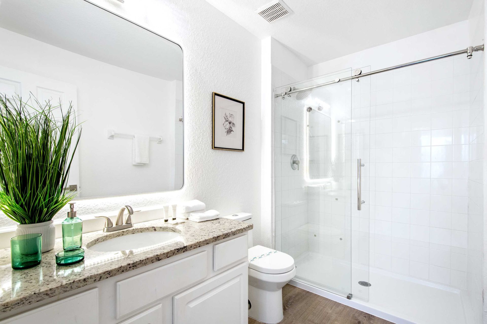 Clean white cabinetry, granite counter, and minimalist design. 