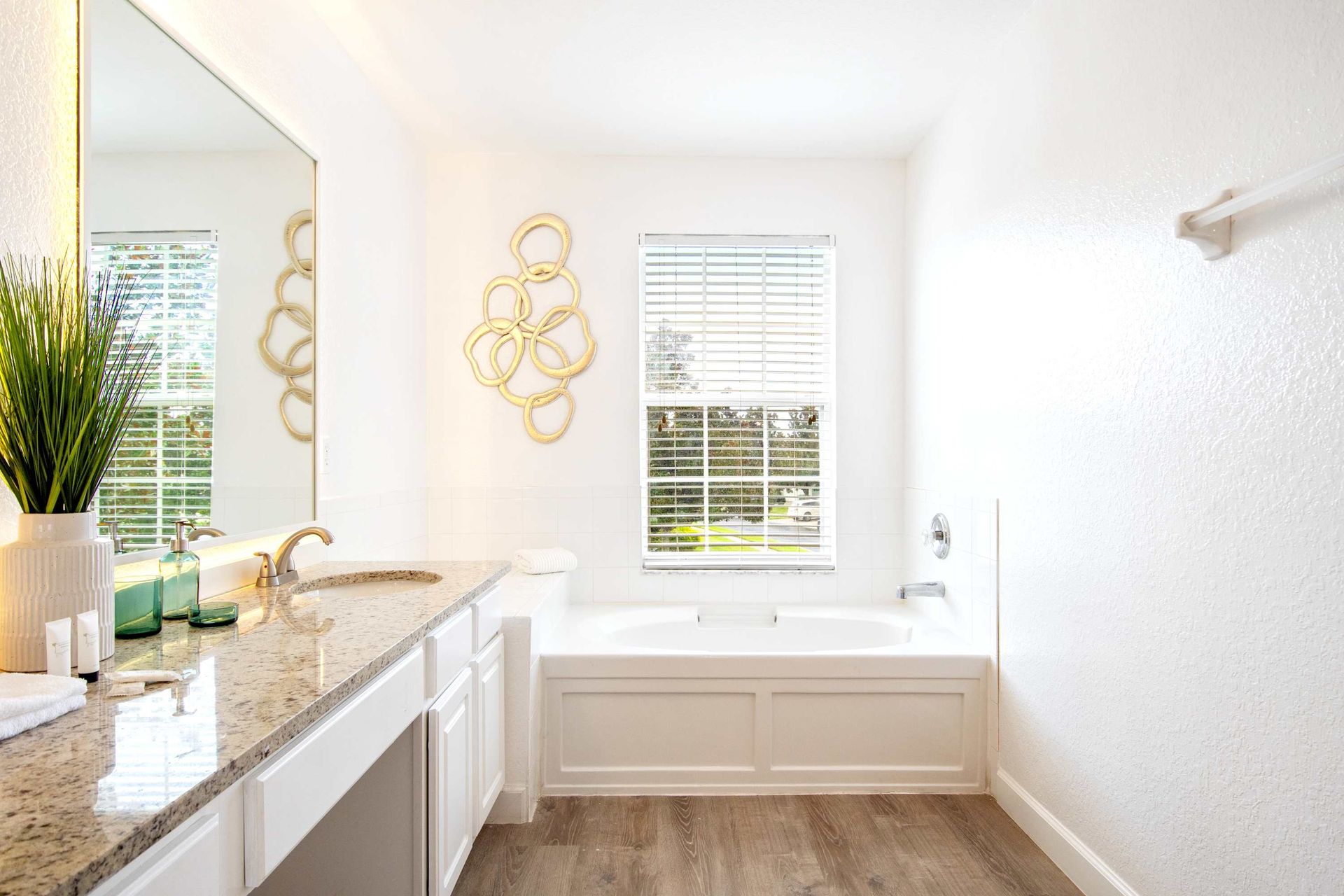 Bright, elegant space with sunlit window and chic gold accent art.