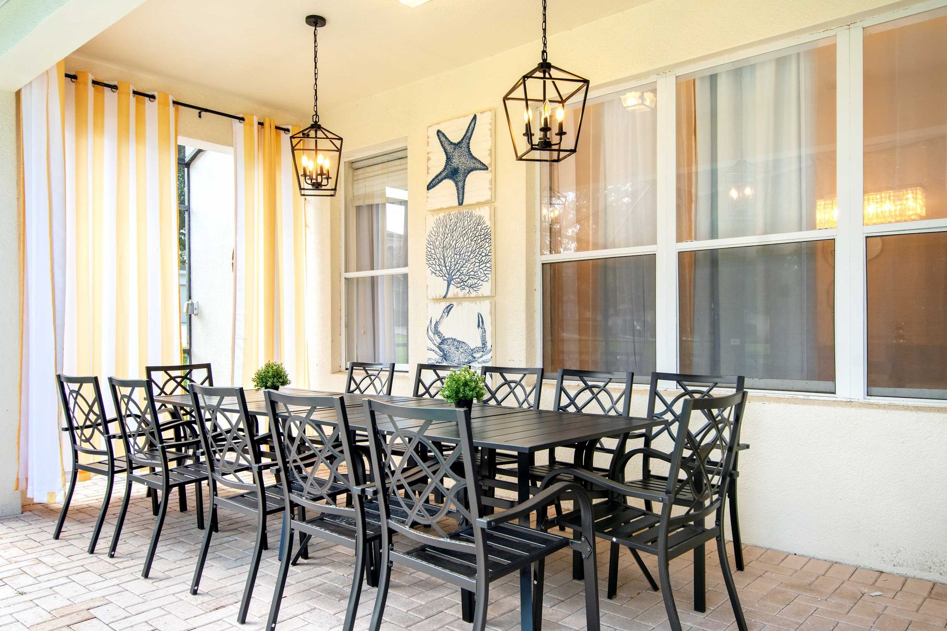 Outdoor dining for a crowd under a shaded patio. 