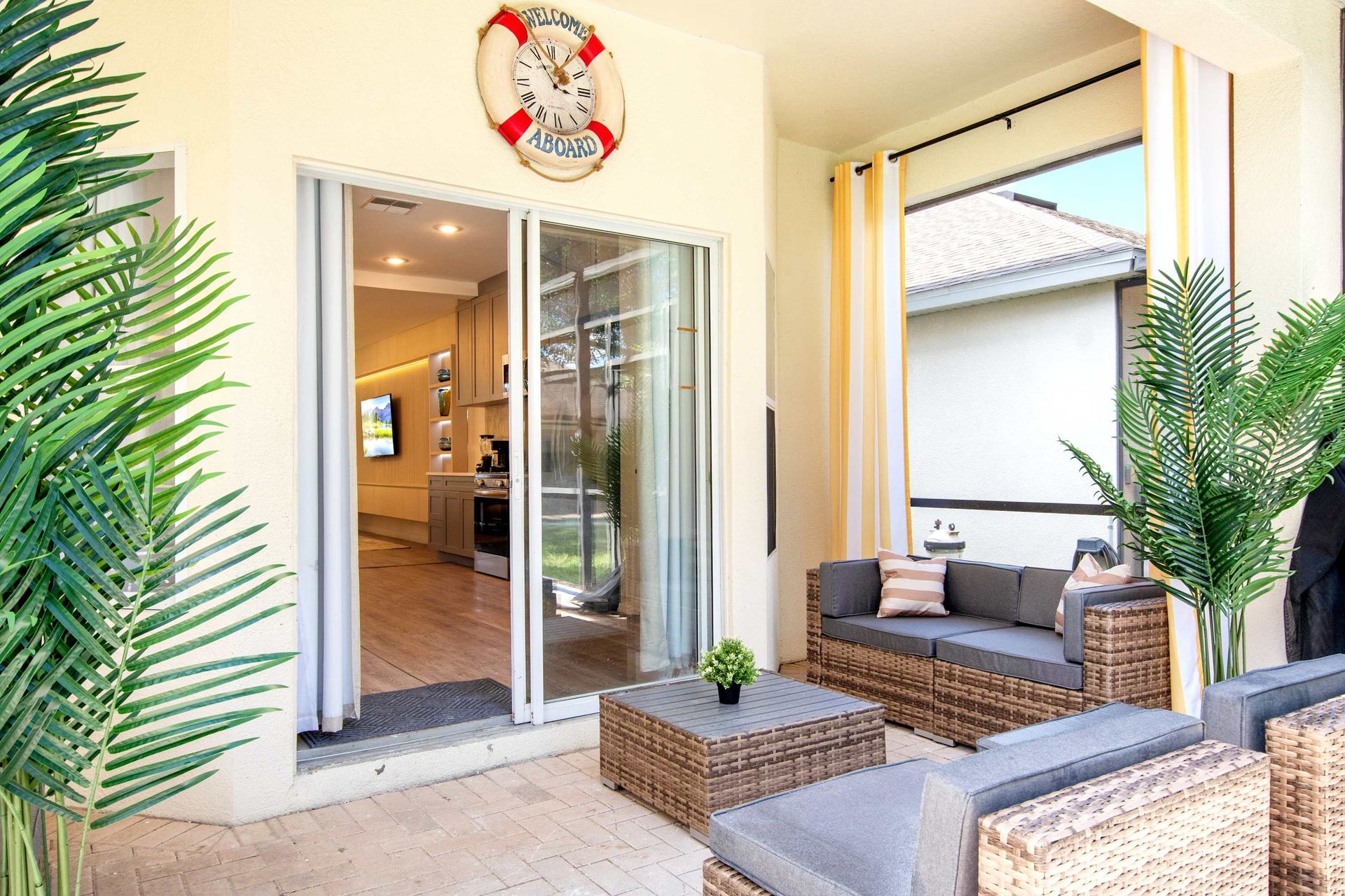Relaxing tropical patio with nautical decor and shaded seating.